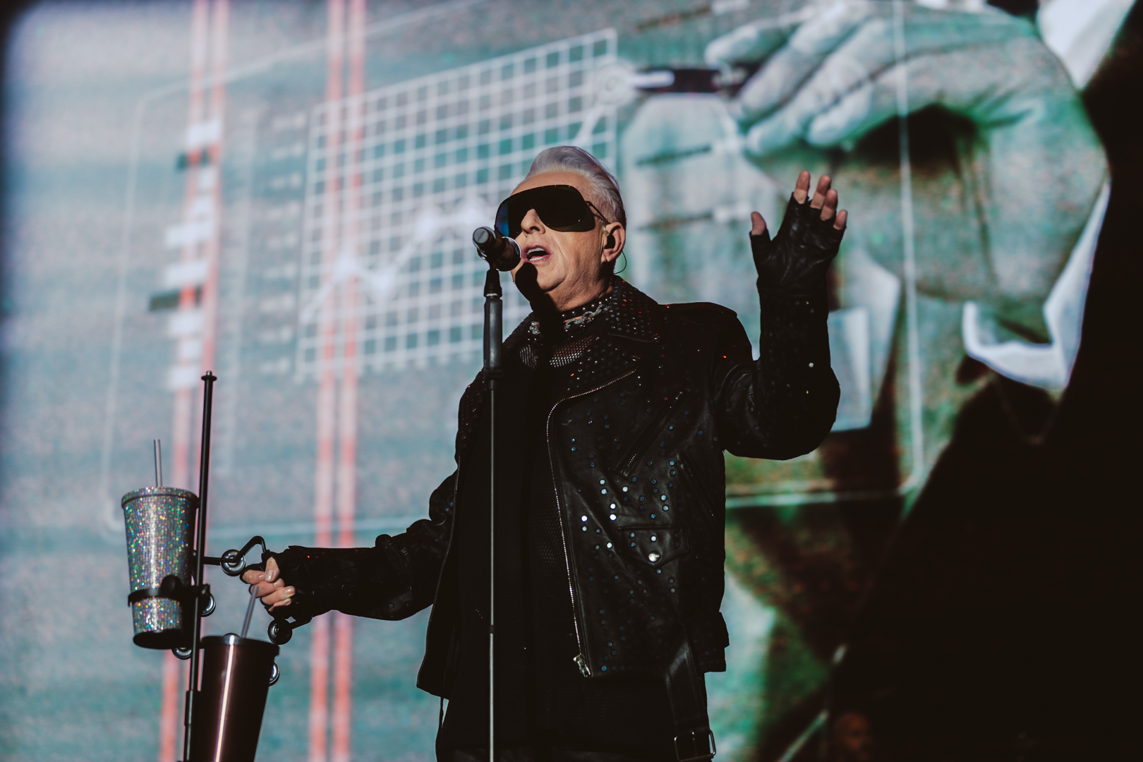 Performer in black leather jacket and sunglasses on stage