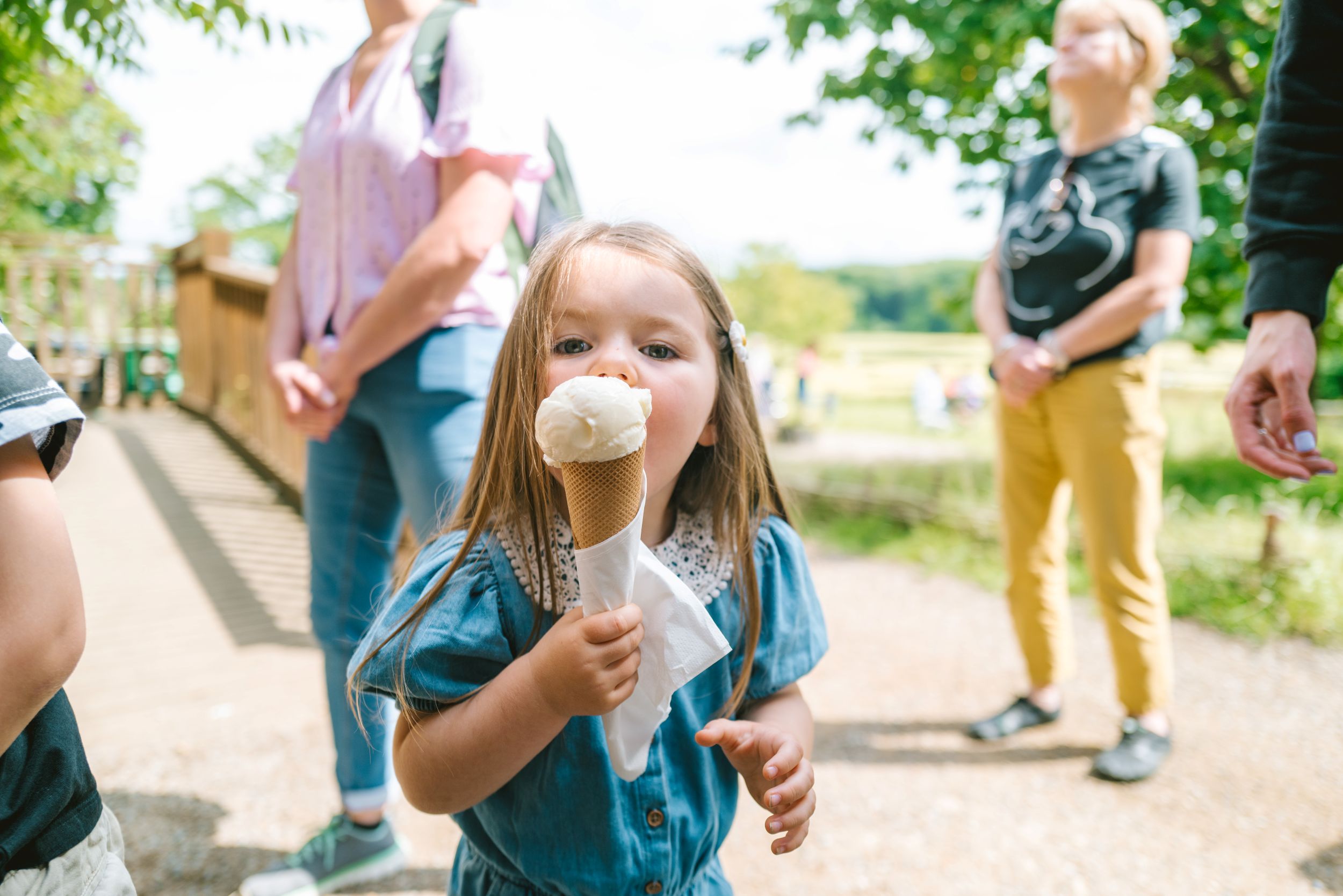 Young girl enjoying ice cream in sunny Yorkshire park