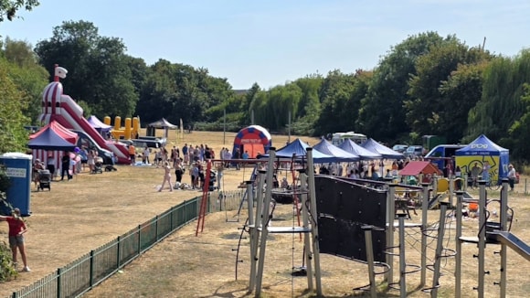 Summer fair with striped helter-skelter and colourful tents