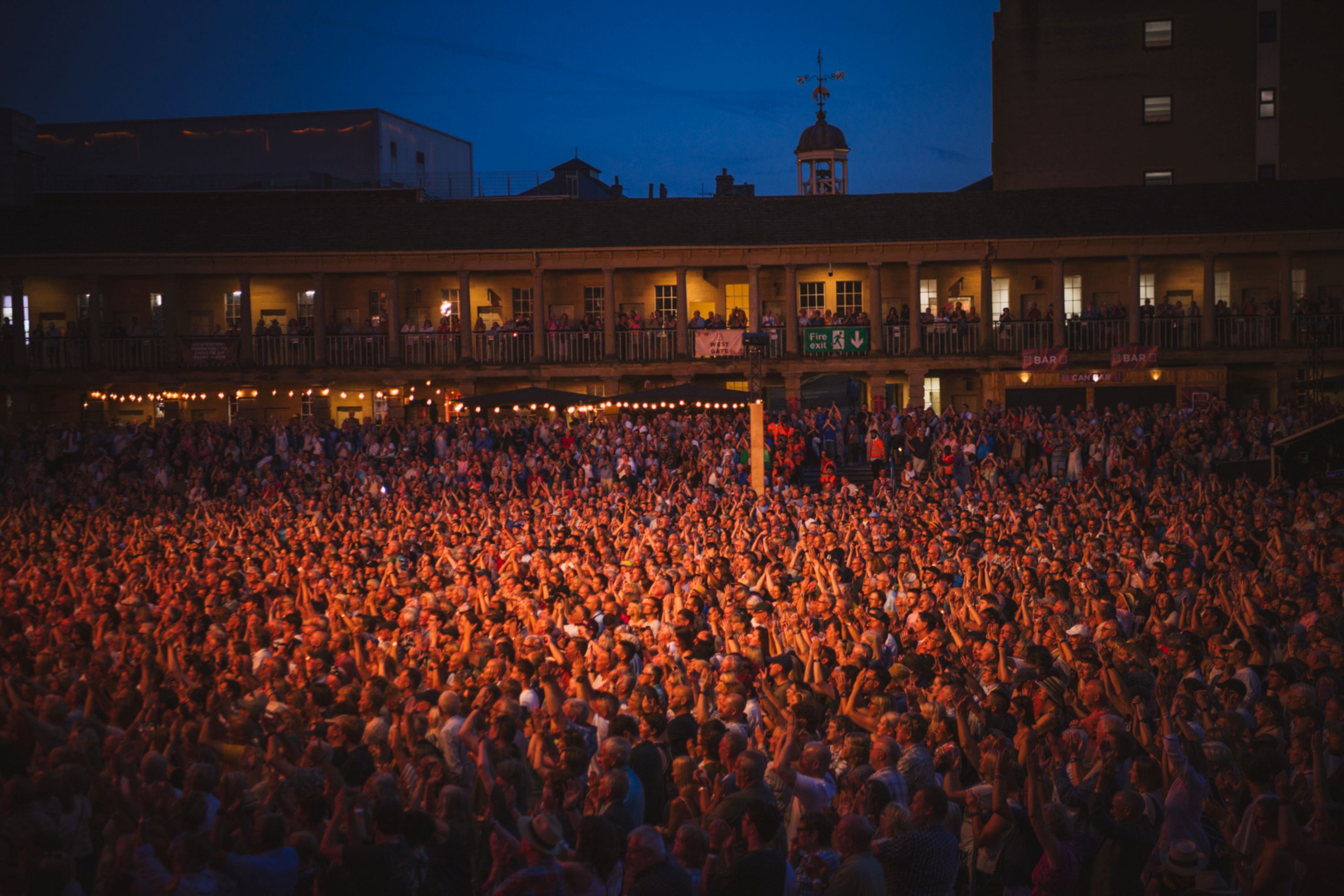 Large crowd enjoying outdoor concert at night in Yorkshire