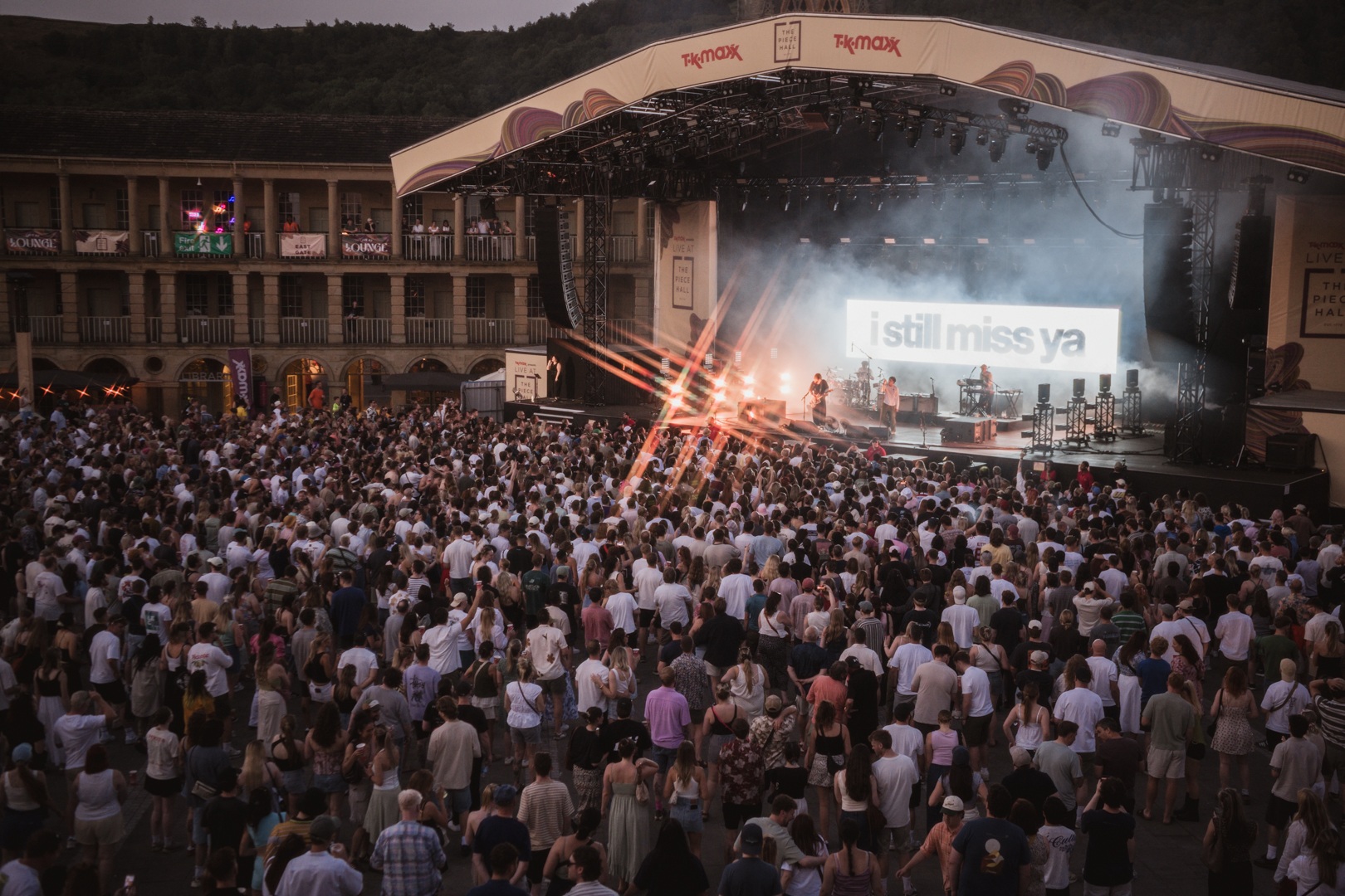 Crowd watching live music performance at outdoor stage