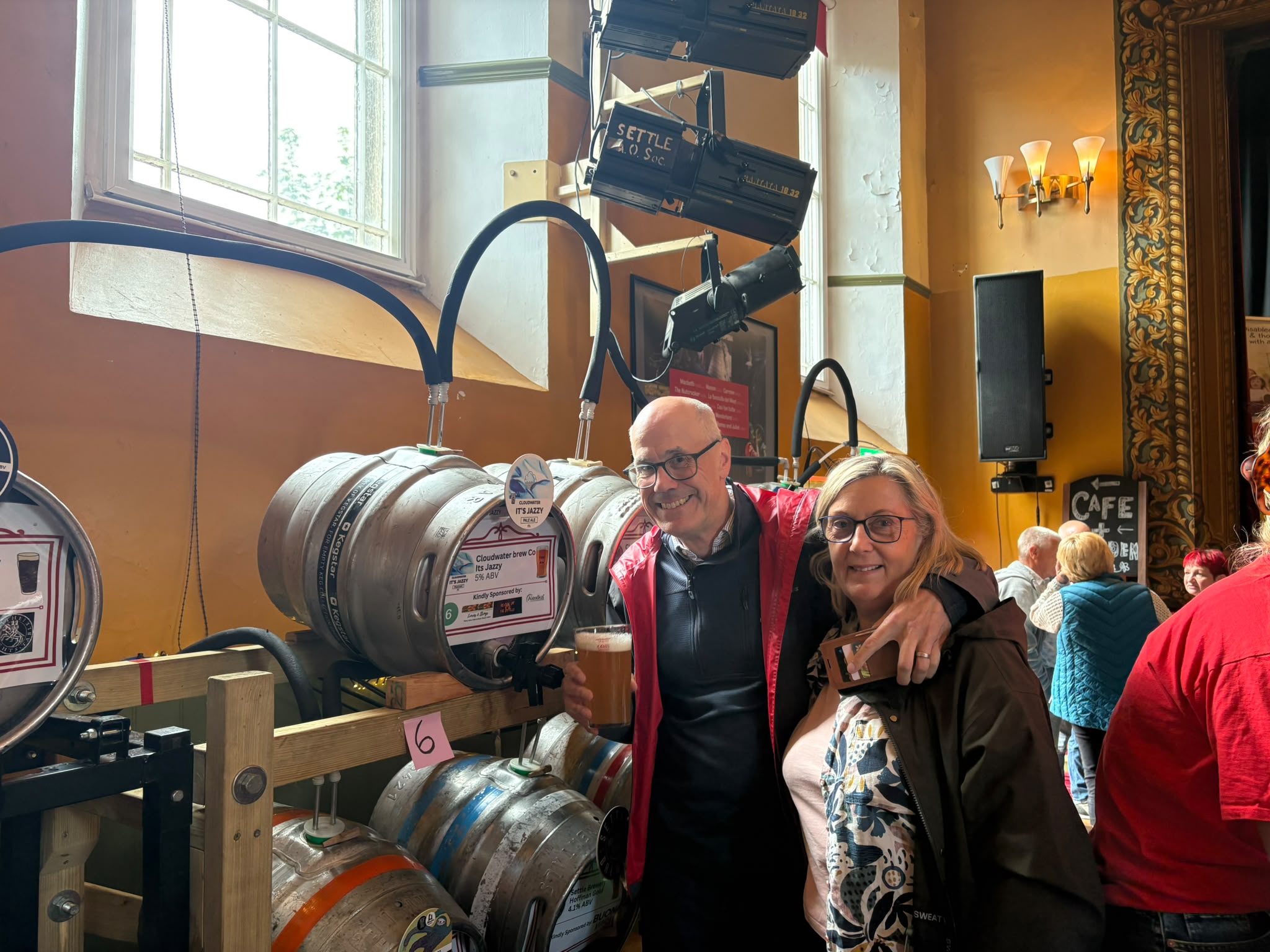 Smiling couple at a beer festival inside a historic pub