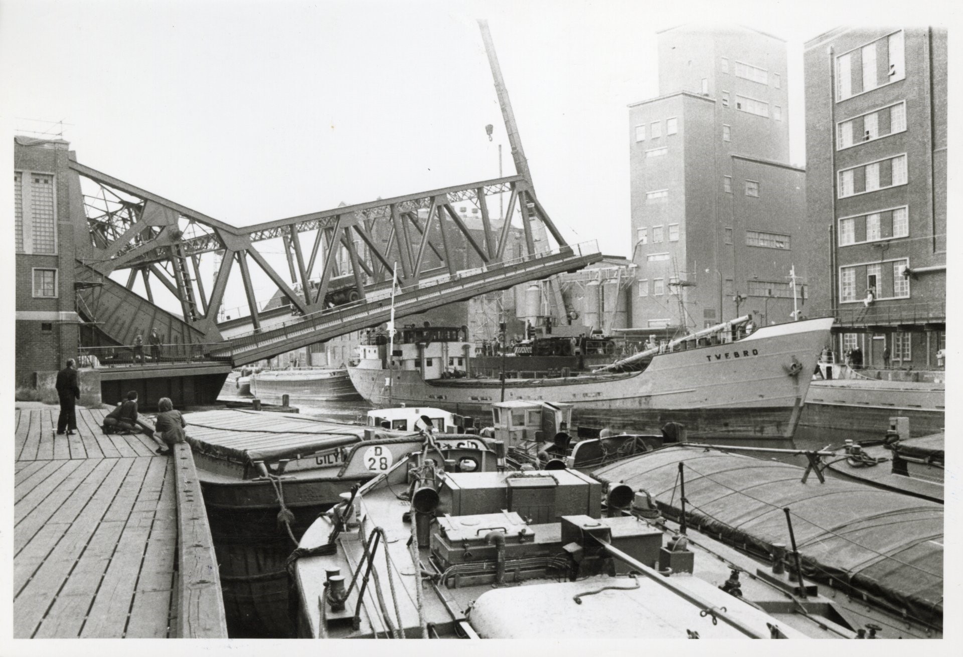 Historic Drypool Bridge over river with cargo ships and warehouses