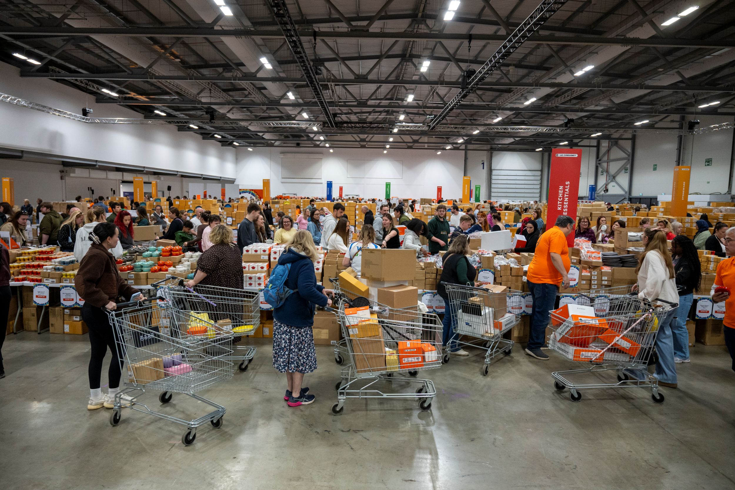 Volunteers organising food donations in a large warehouse
