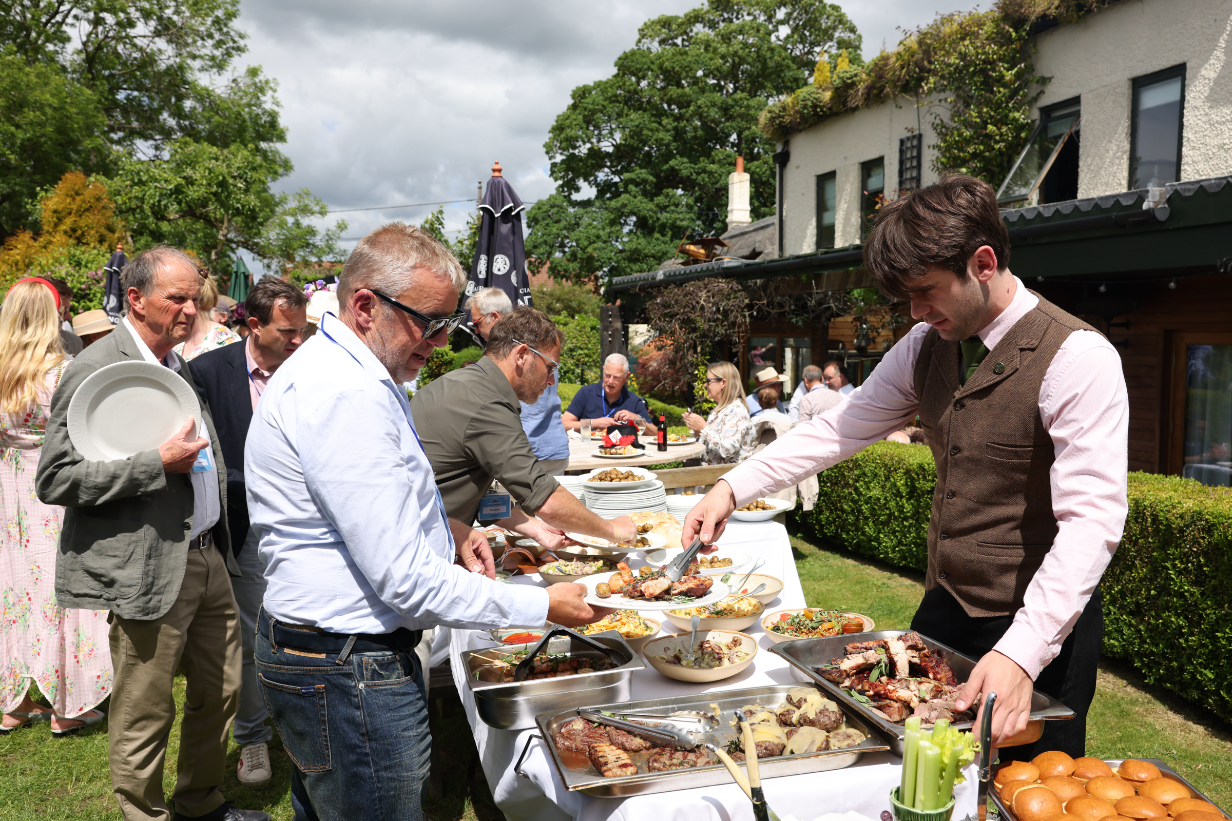 Guests enjoying outdoor buffet at a garden event