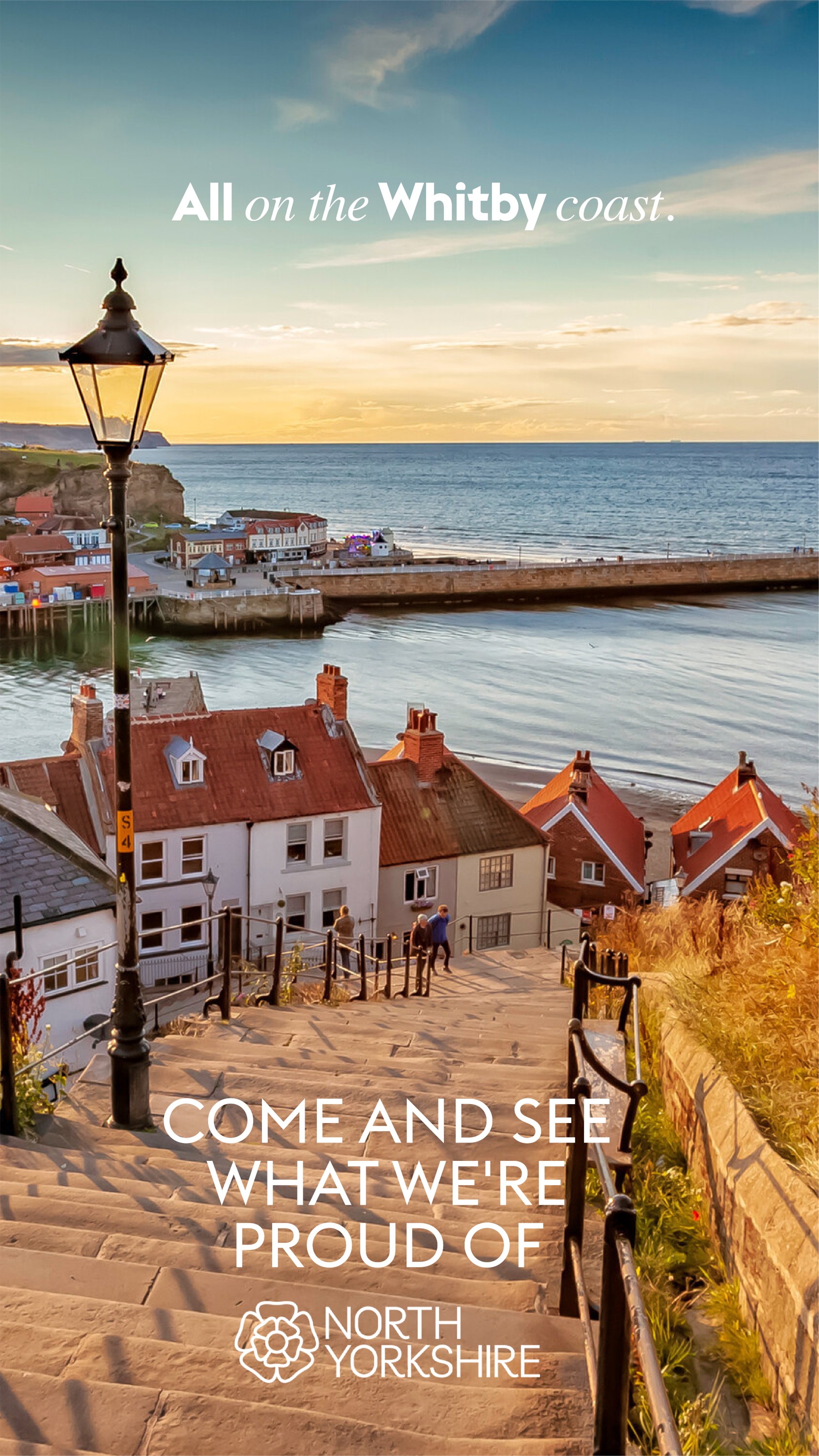 Sunset view over Whitby harbor with red-roofed cottages