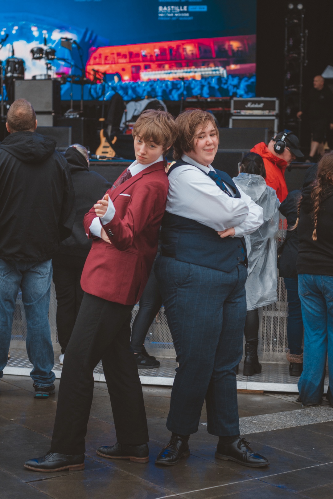 Two people in formal attire posing at an outdoor event