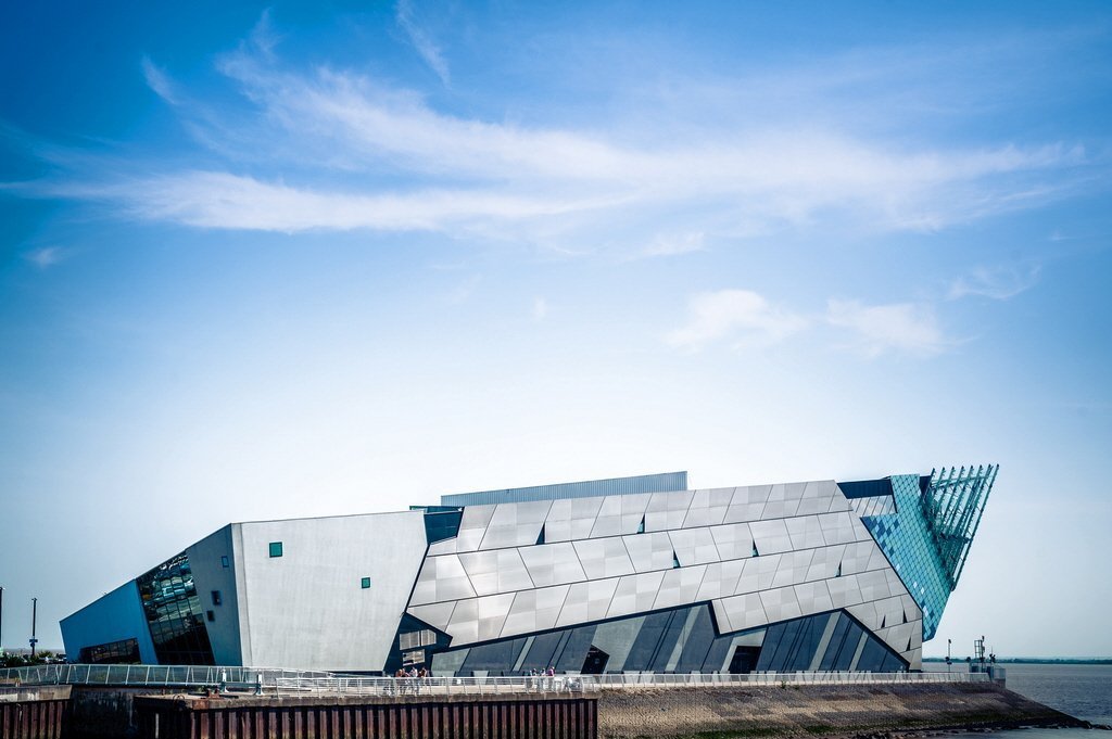 Futuristic metallic building with angular design under blue sky