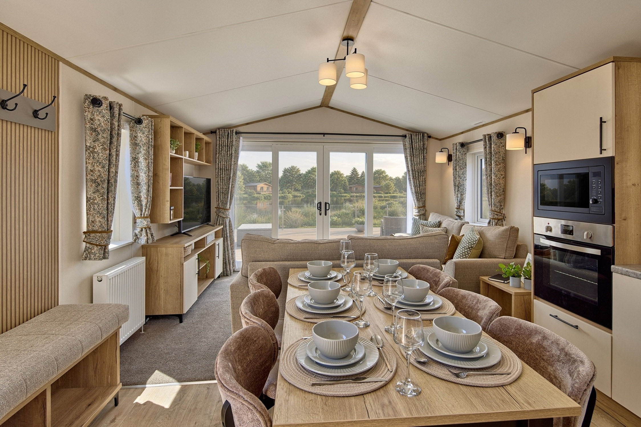 Cosy caravan interior with dining table and large windows