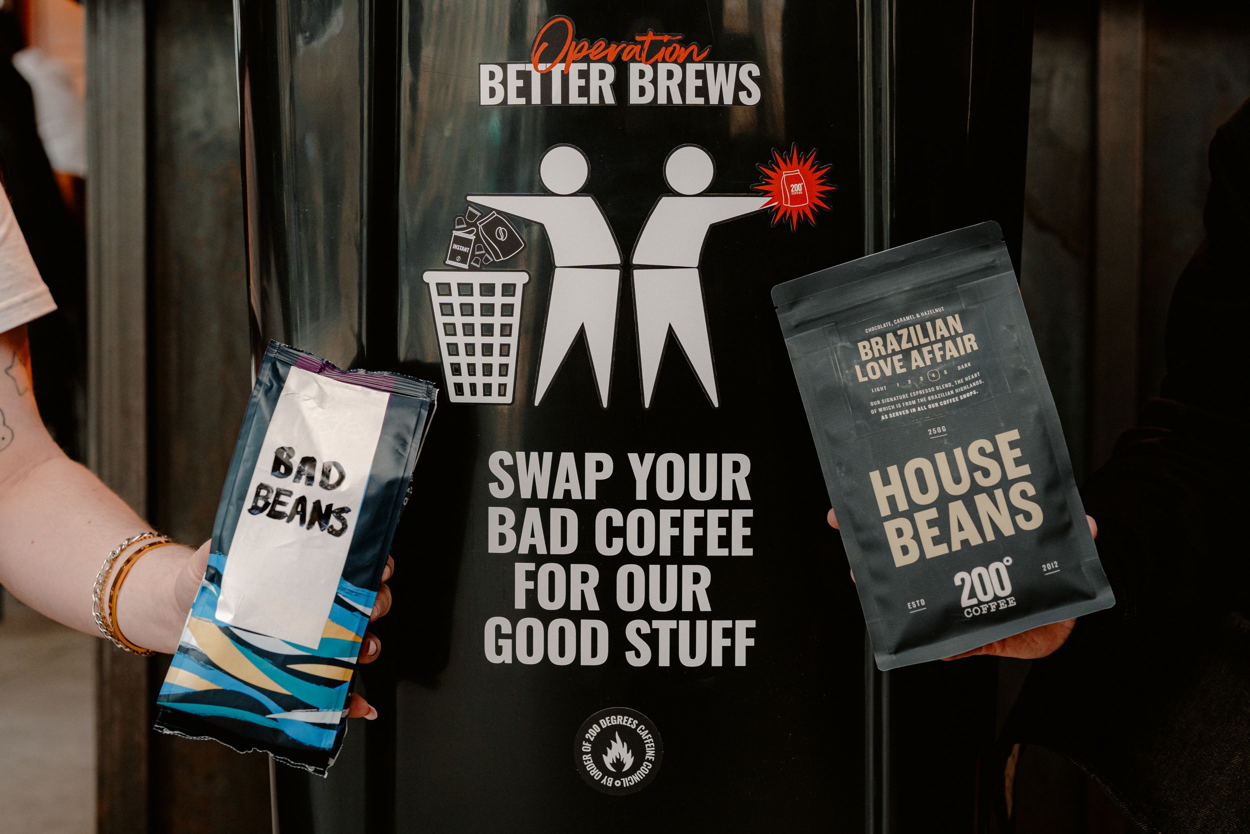 People holding coffee bags in front of a swap-your-coffee sign