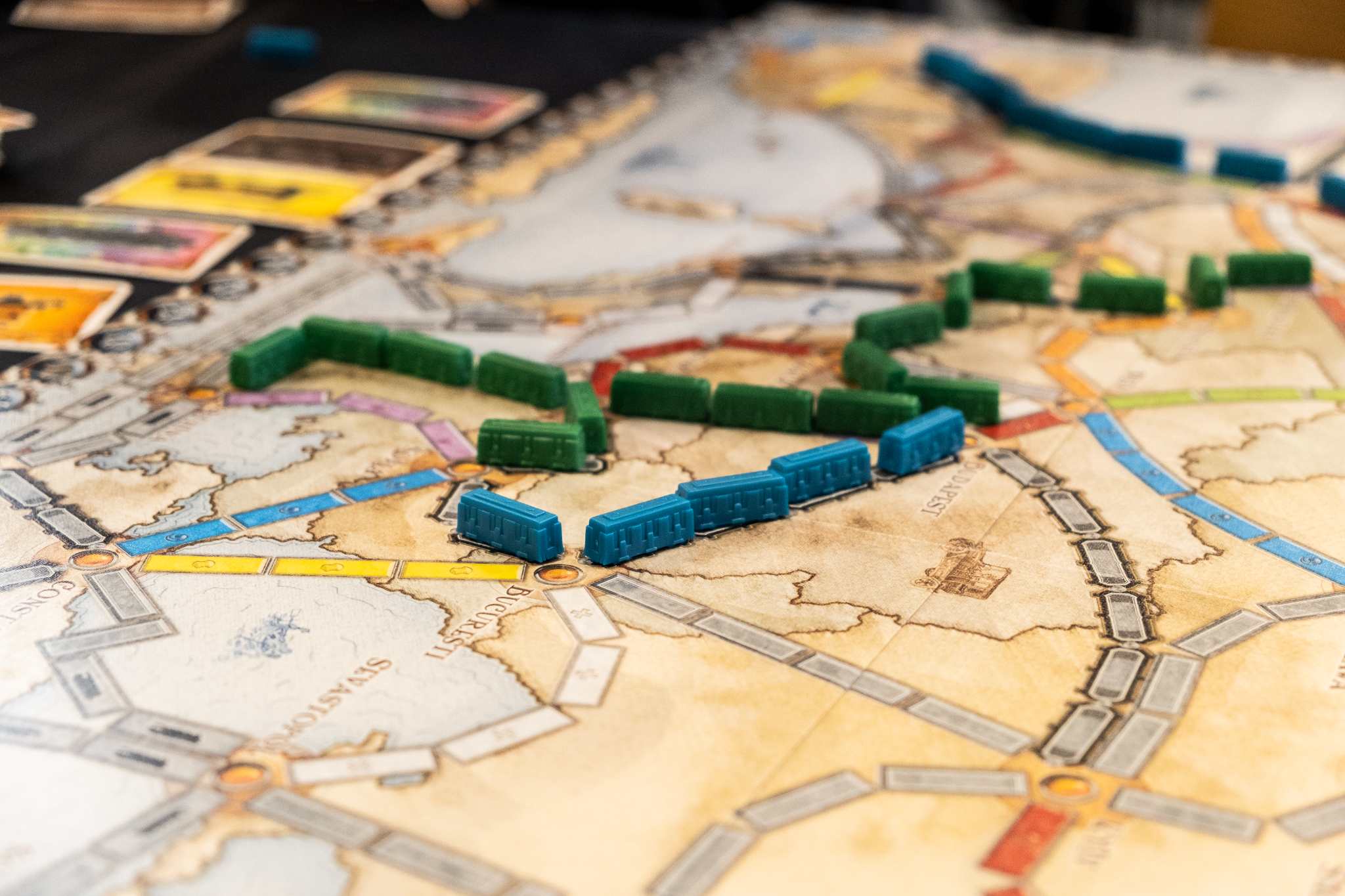 Board game with colourful train pieces on a vintage map