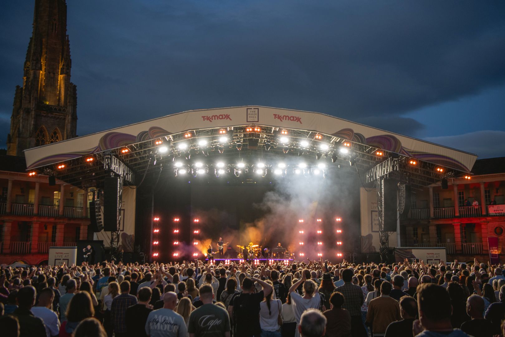 Evening concert at outdoor venue with large crowd and stage lights