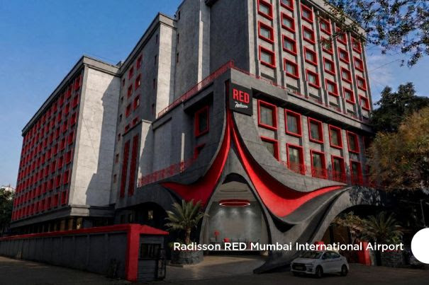 Modern hotel with red and grey facade and unique entrance