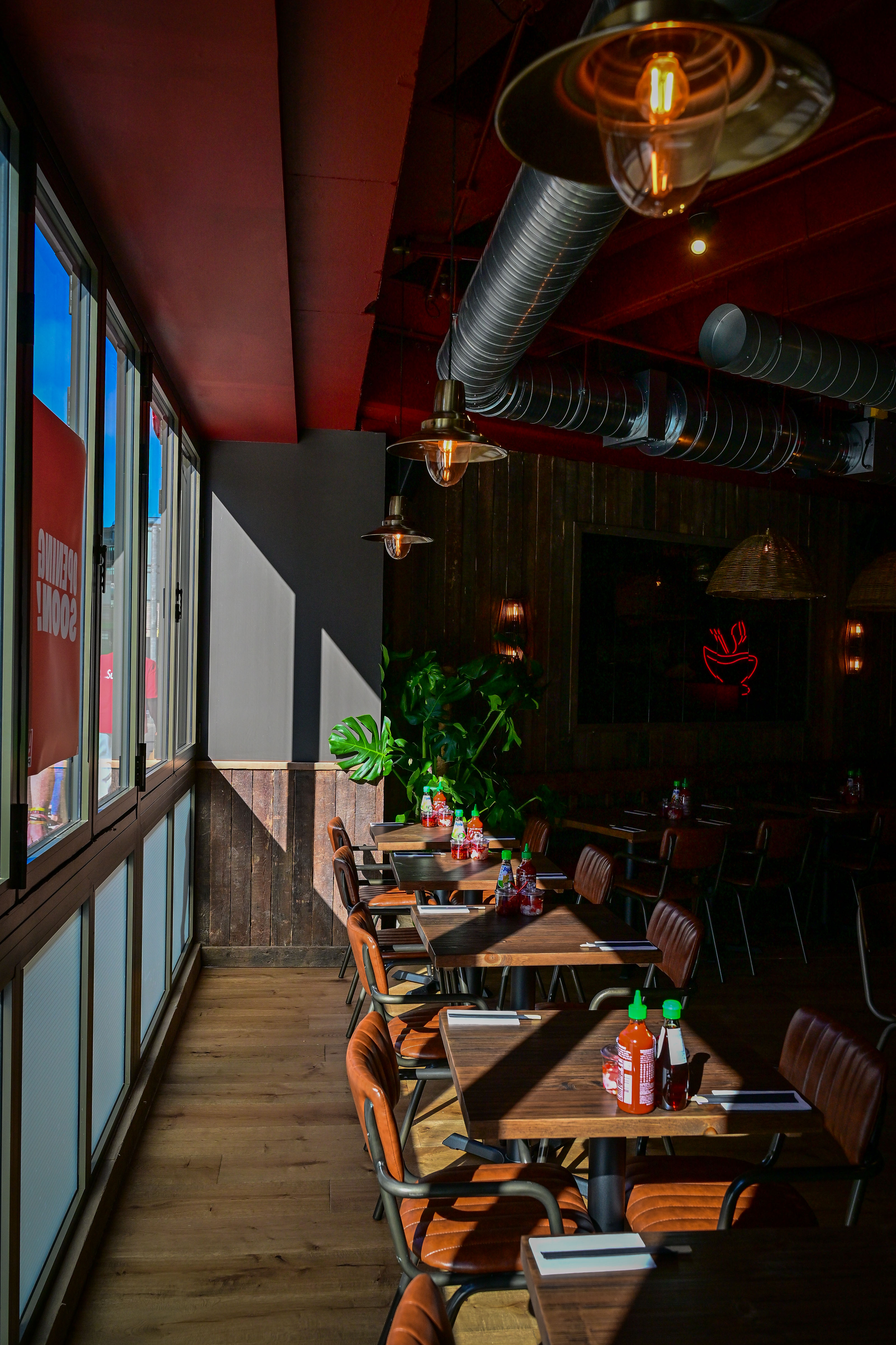 Cosy cafe interior with wooden decor and sunlight streaming in