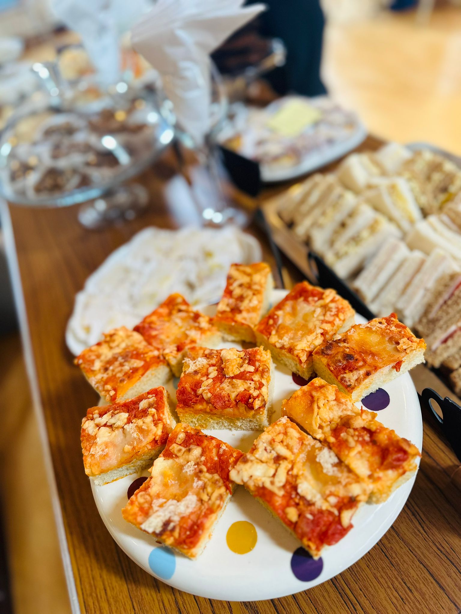 Close-up of a platter with caramel-topped cakes on a wooden table