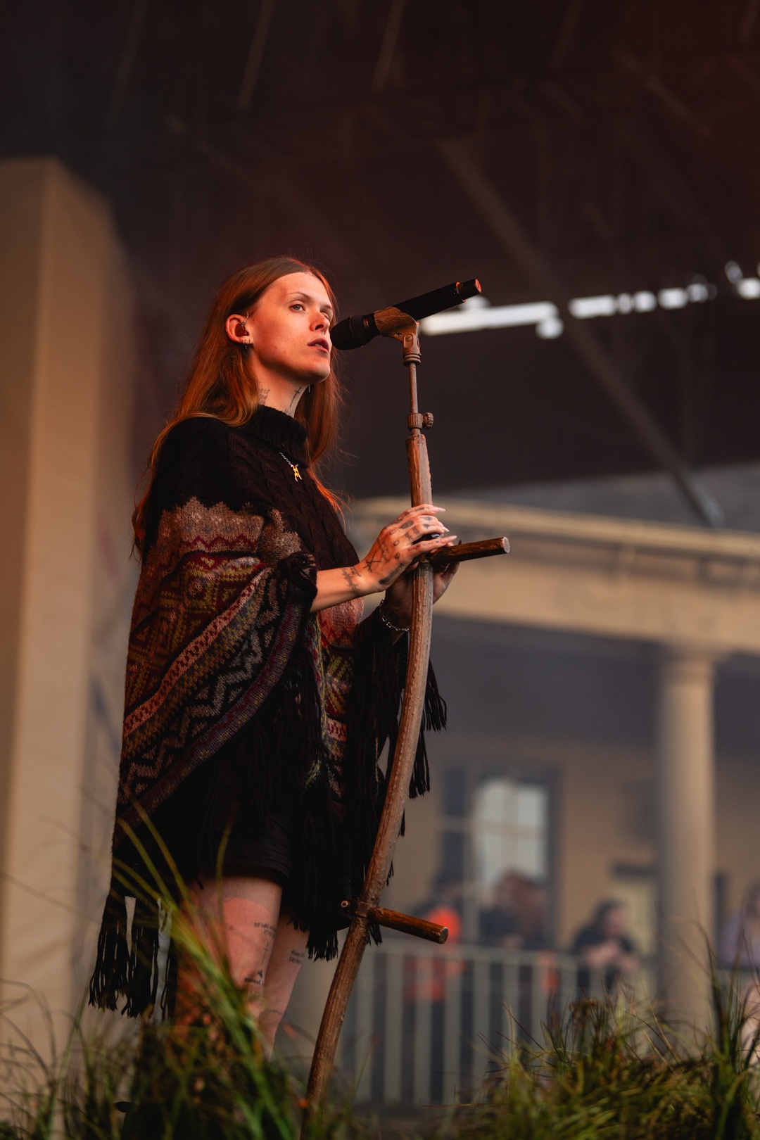 Female musician performing on stage with microphone stand