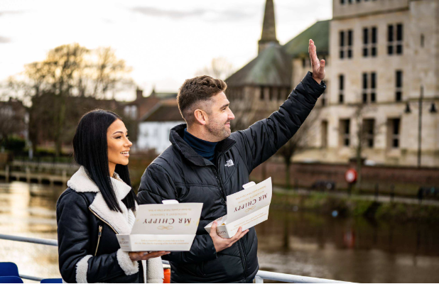 Couple enjoying fish and chips by the River Ouse in York