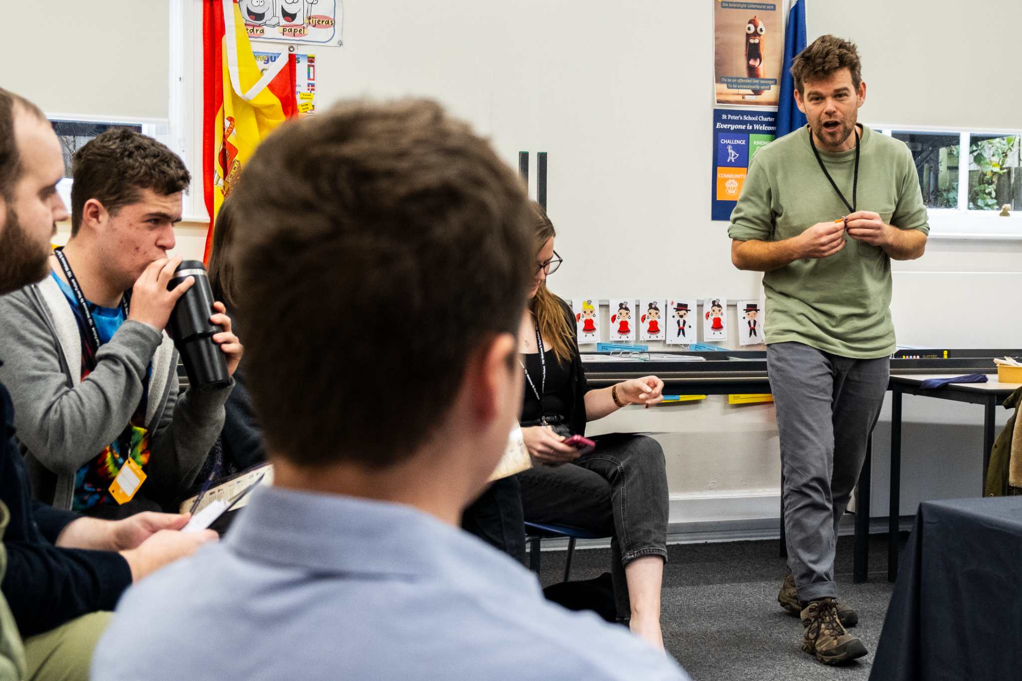 Man in casual attire giving a presentation to seated group