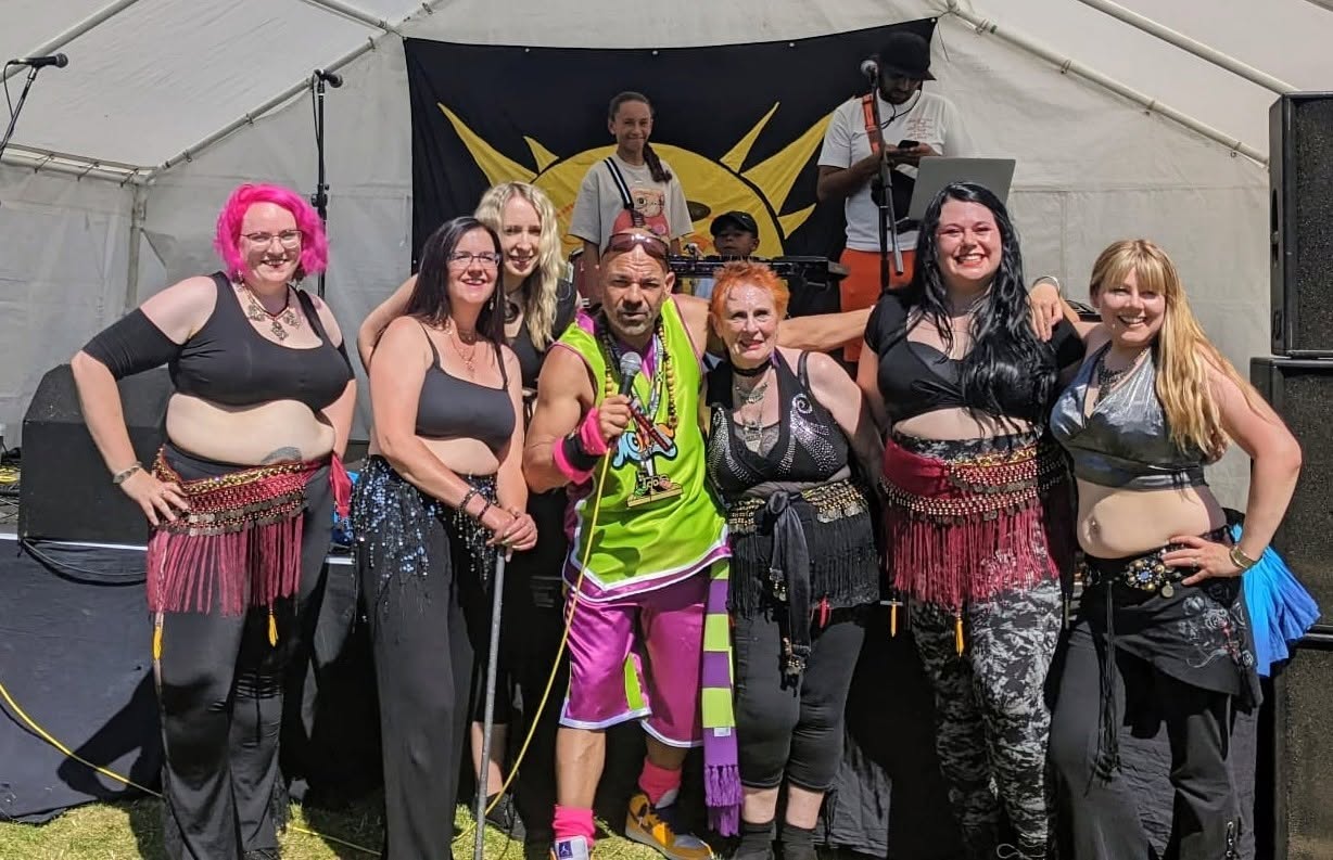Group of belly dancers with colorful costumes at outdoor festival