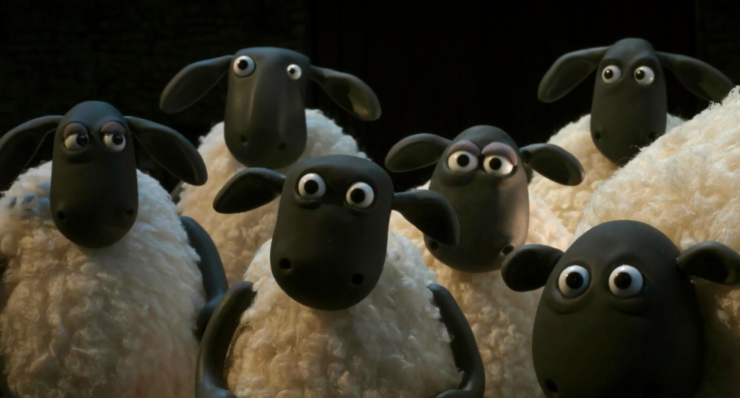 Group of animated sheep with wide eyes in a dark setting - The Wrong Trousers