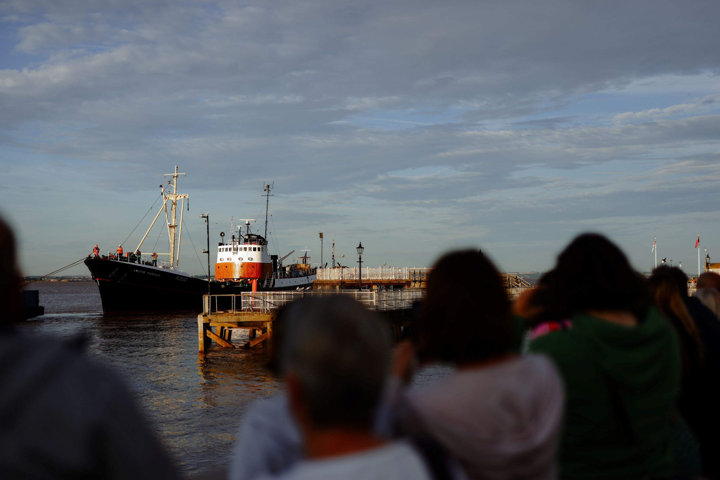 Historic ship docked at Whitby harbour under cloudy sky