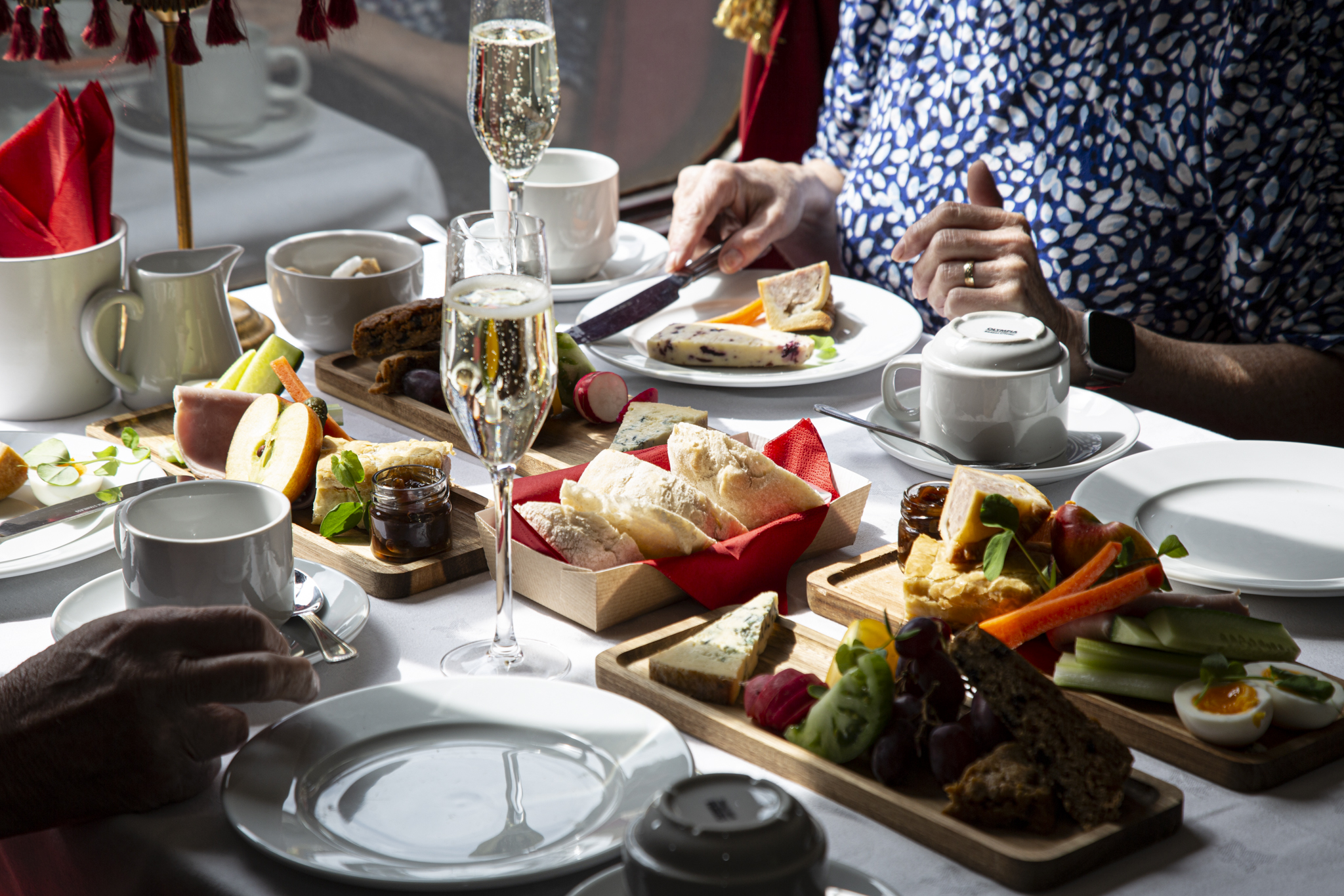 Elegant afternoon tea setting with pastries and champagne