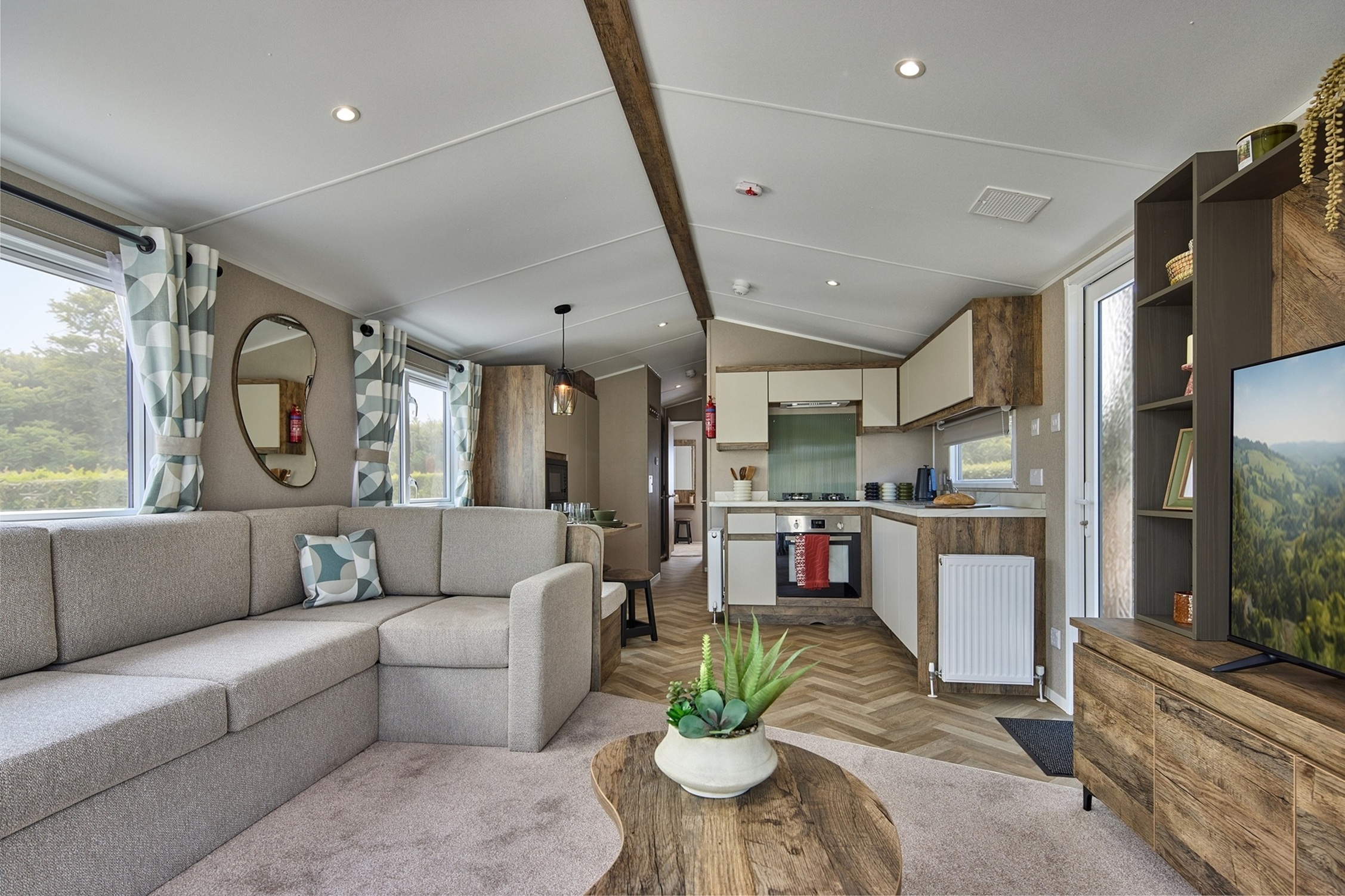 Cosy modern caravan interior with neutral decor and large windows