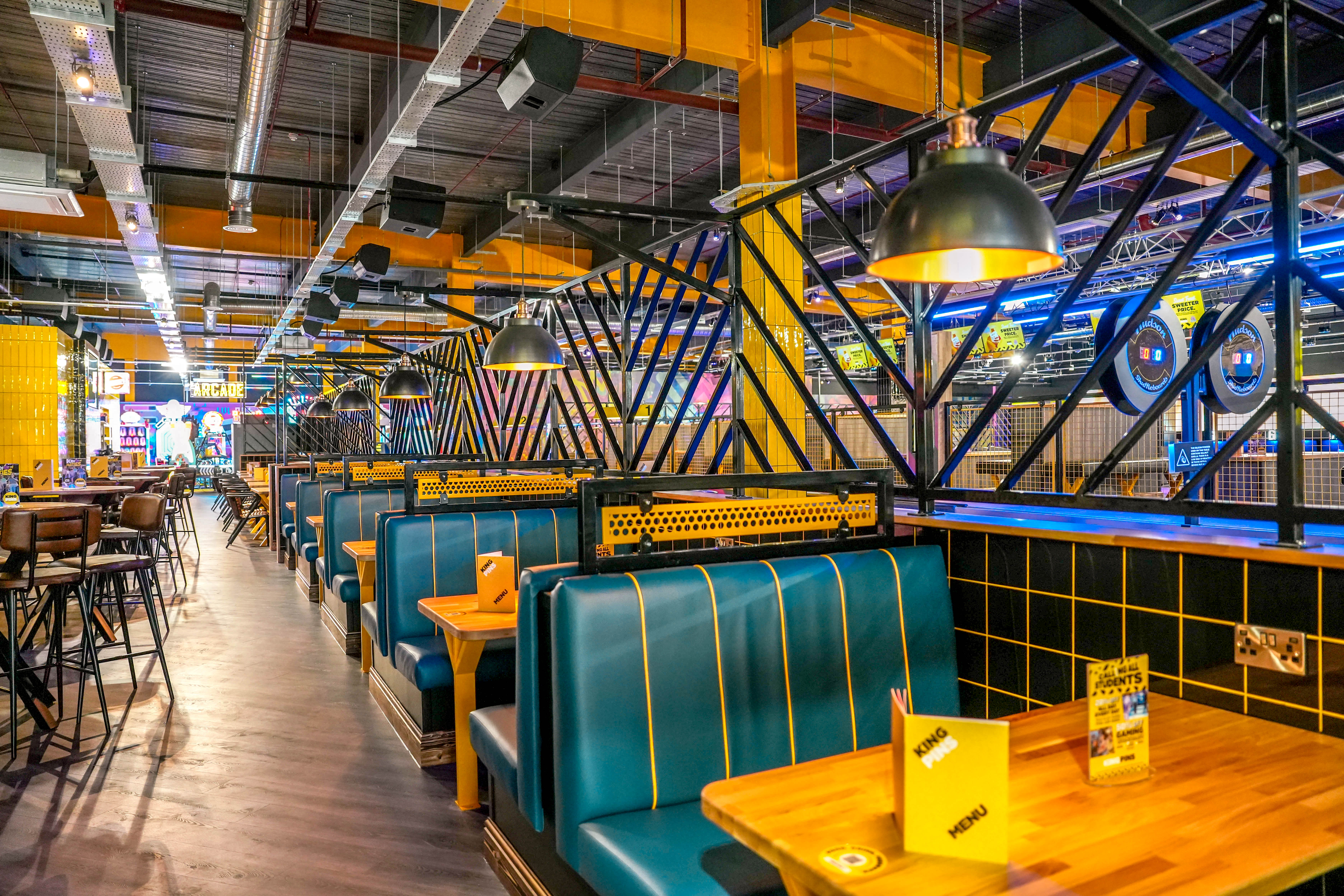 Vibrant indoor food market with colorful seating and lights