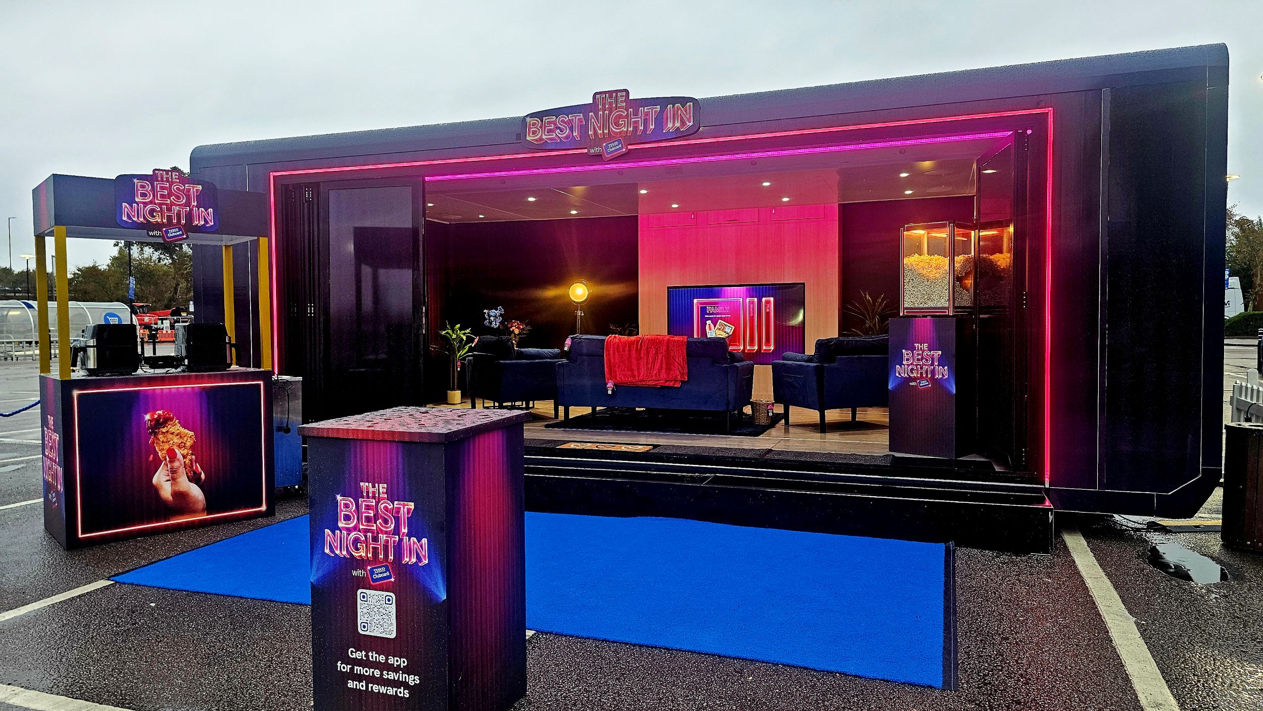 Cosy lounge setup with neon lights and modern furniture at event
