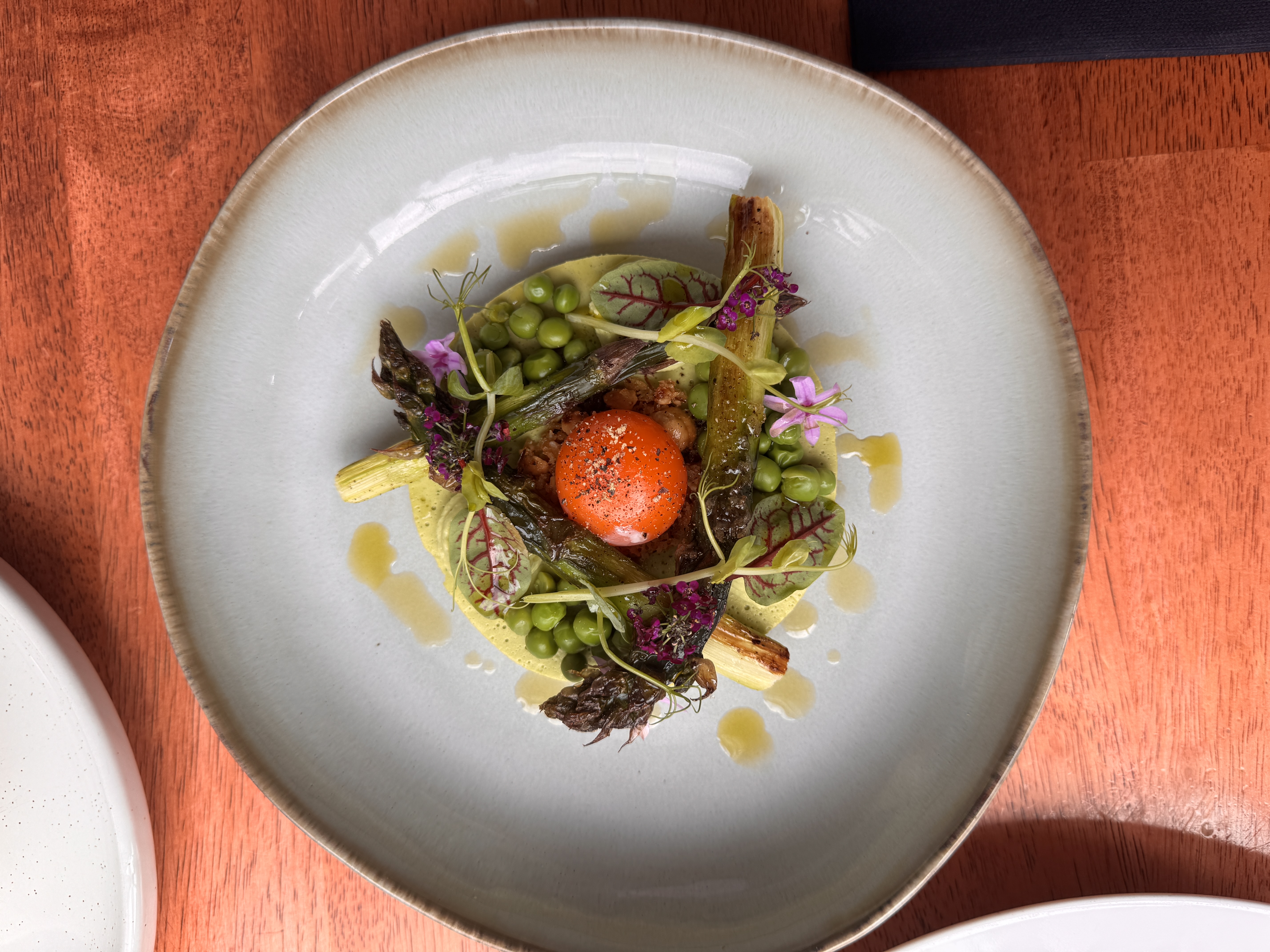 Gourmet dish with vegetables and a bright orange center