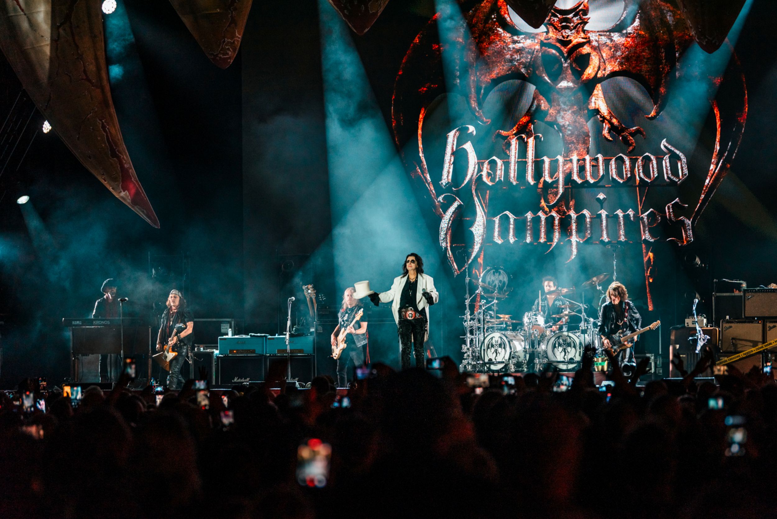 Rock band performing on stage with dramatic lighting