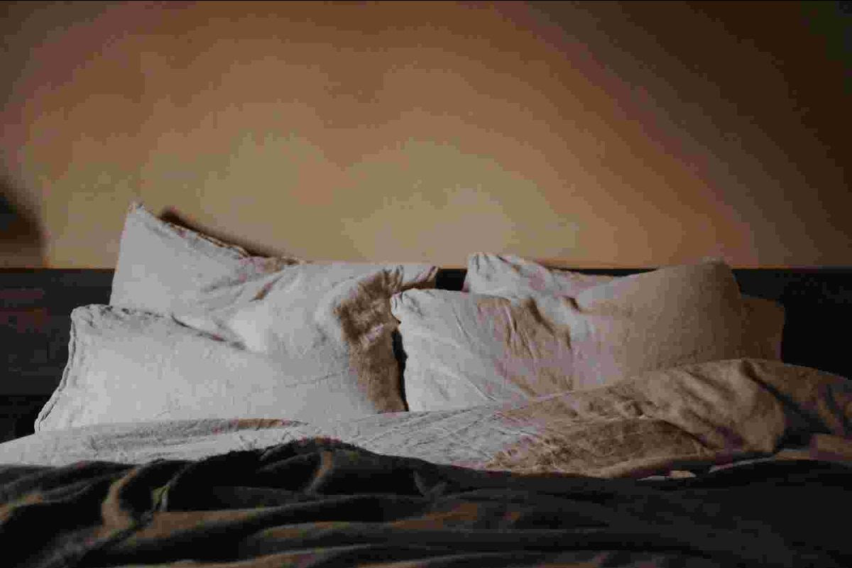 Cozy bed with white pillows and soft lighting