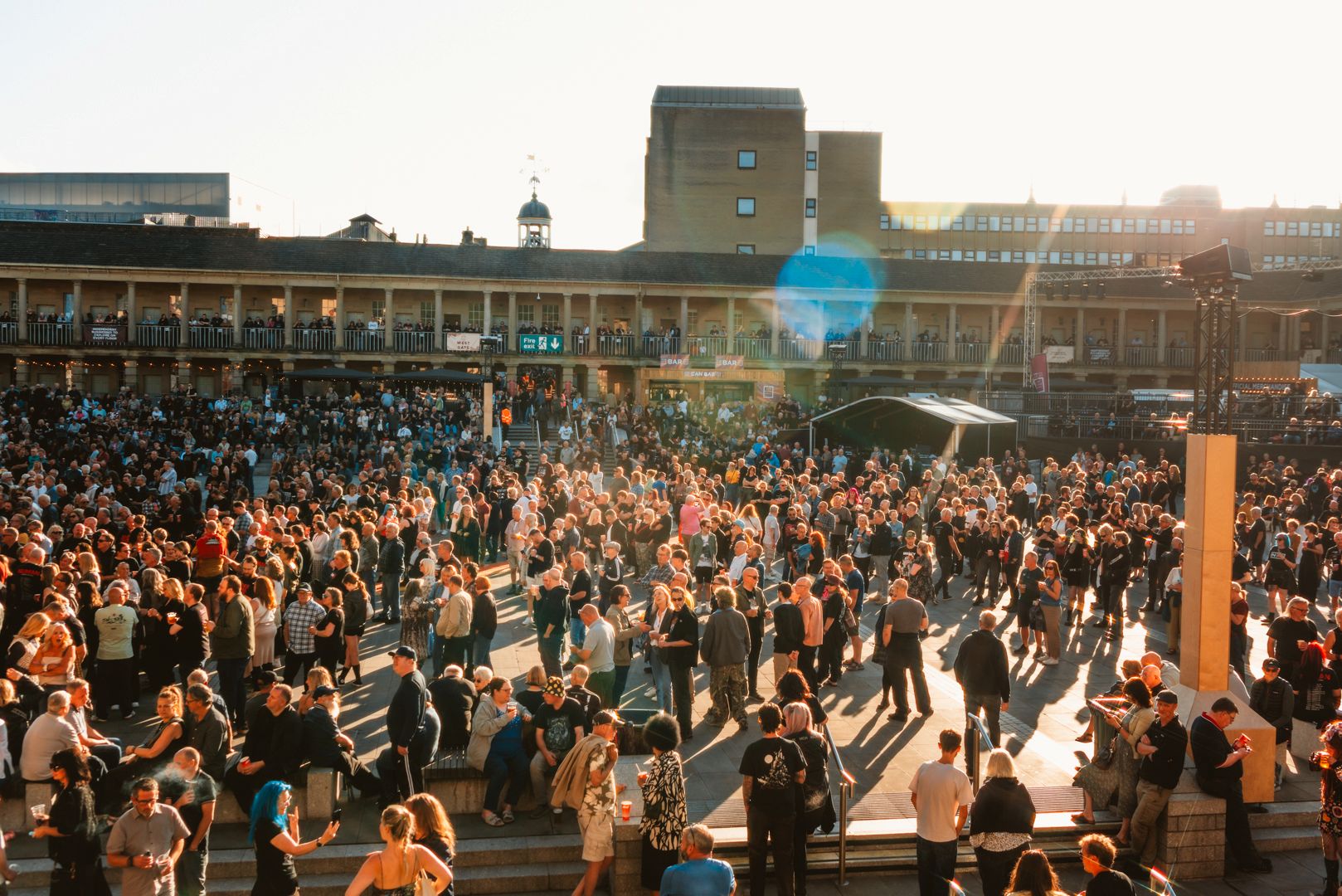 Crowd enjoying sunny day at Halifax Piece Hall courtyard