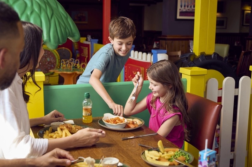 Children enjoying food at a colorful family restaurant