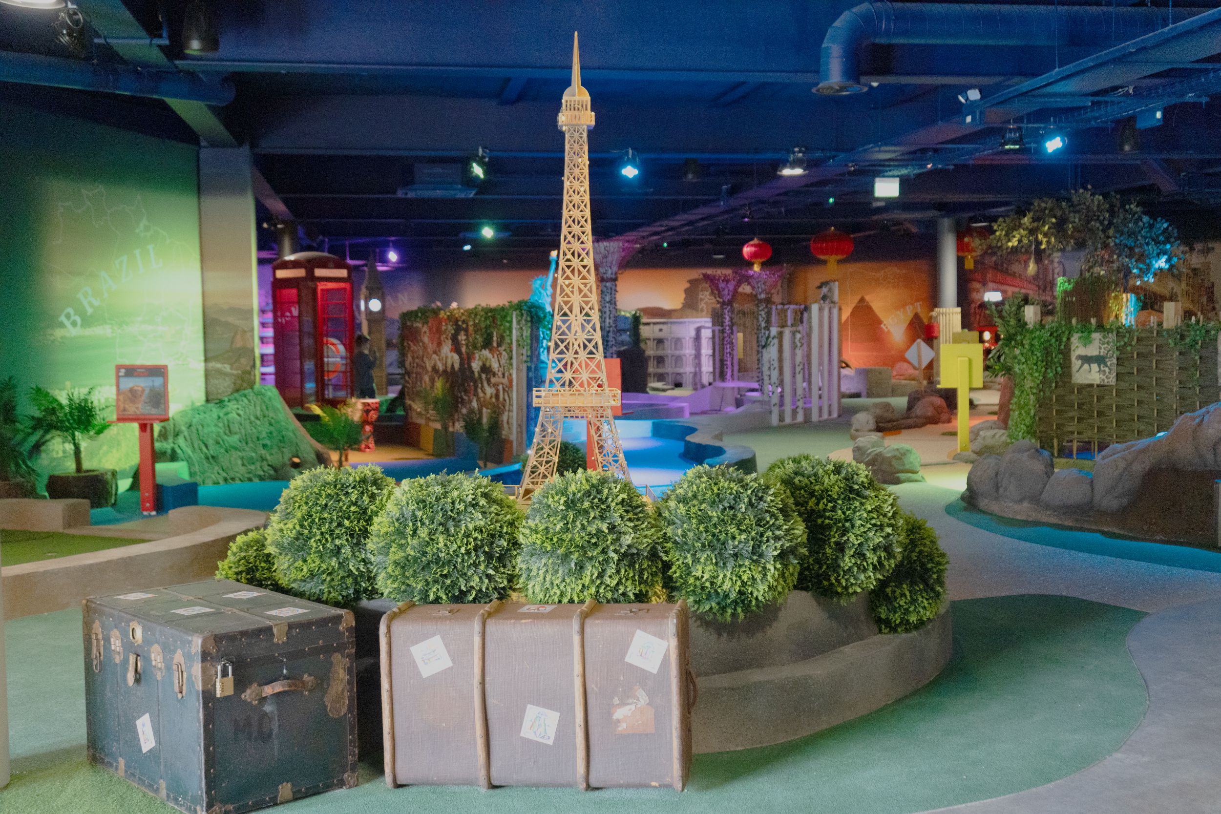Indoor mini-golf course with world landmarks and travel theme