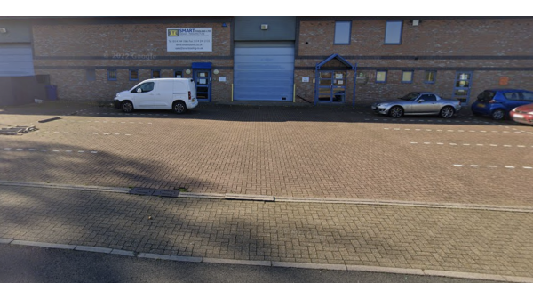 Pay & Display parking area in Attercliffe, Yorkshire, with a white van and a silver car parked alongside a brick building.