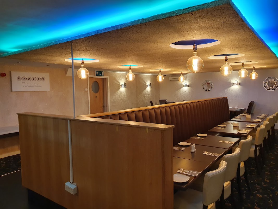 Modern takeaway interior with wooden seating, pendant lights, and blue ambient lighting in Beadlam, Yorkshire.