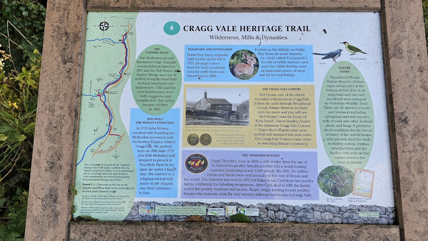 Information board detailing the Cragg Vale Heritage Trail, featuring maps, text about local history, and illustrations of wildlife.