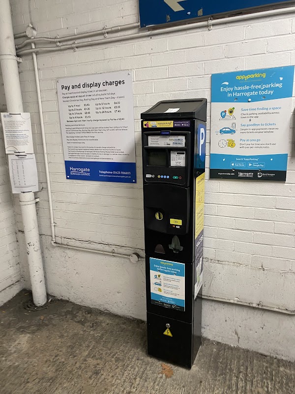 Pay & Display parking machine in West Park Multi Storey Car Park, with signage detailing charges and parking app info.