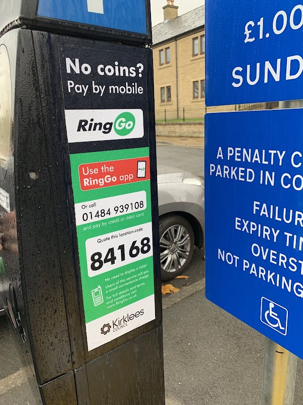 Parking payment station with RingGo instructions, a phone number, and a location code in Springwood Car Park, Huddersfield.