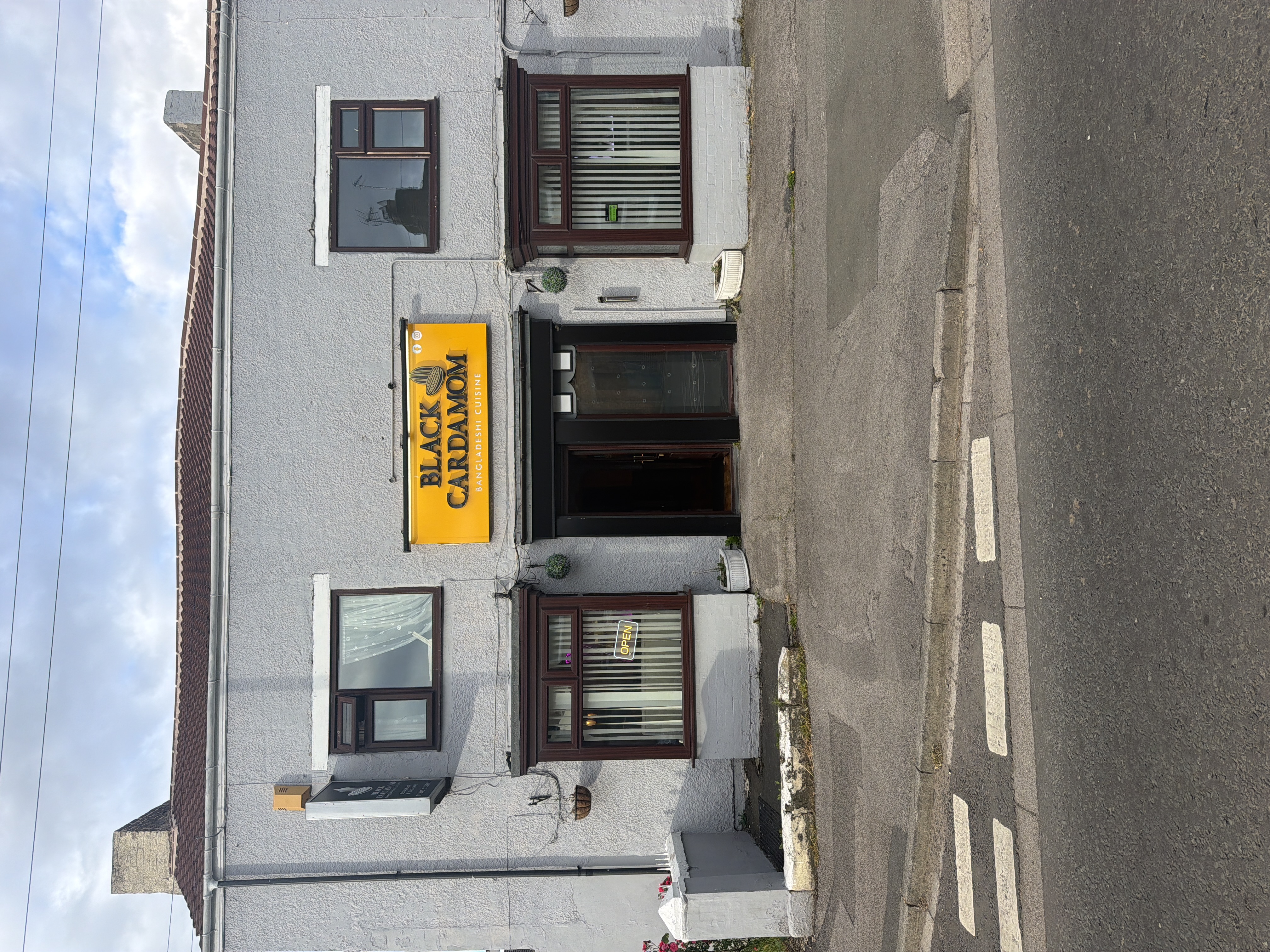 Traditional Yorkshire restaurant exterior with hanging baskets and bright yellow signage