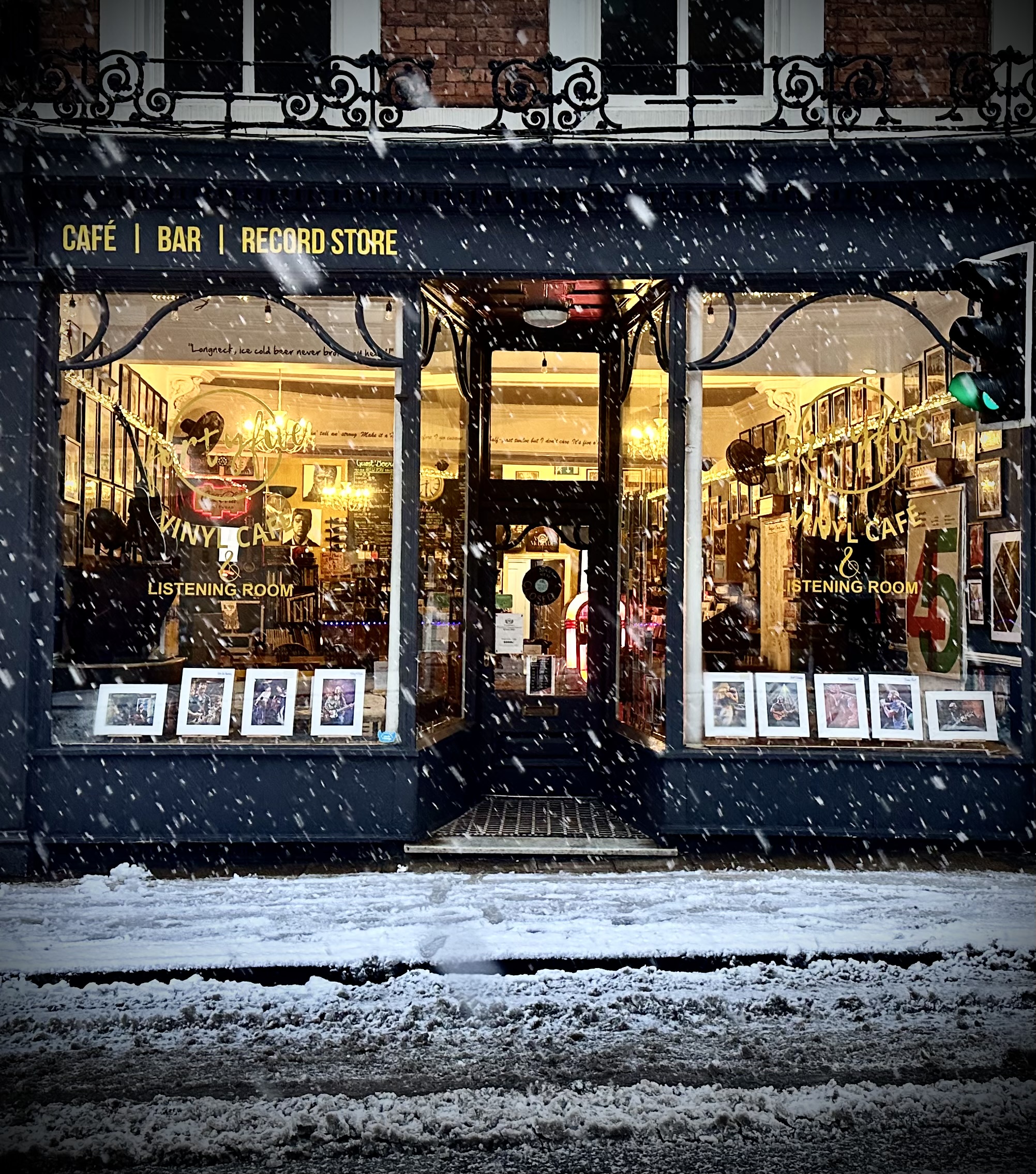 Charming café exterior with vintage records and snow-covered street