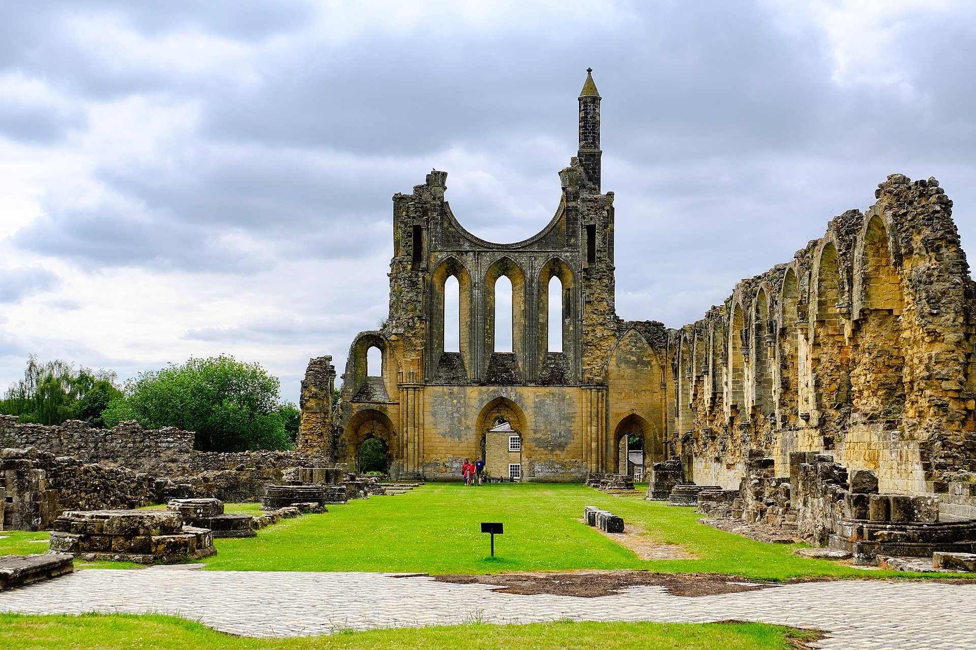 Historic abbey ruins with arched windows and green lawns