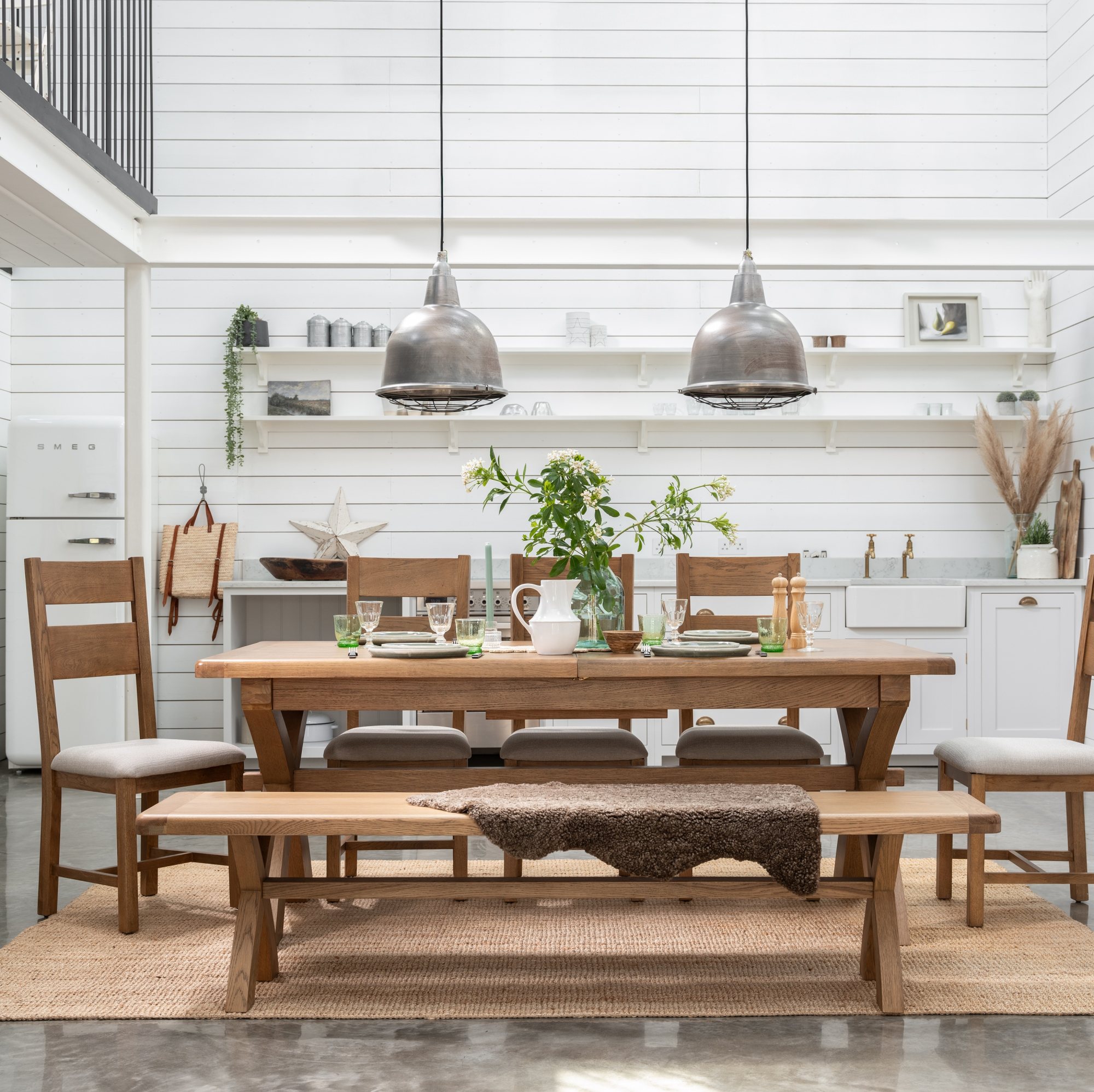 Rustic dining room with wooden table, bench seating, and industrial pendant lights