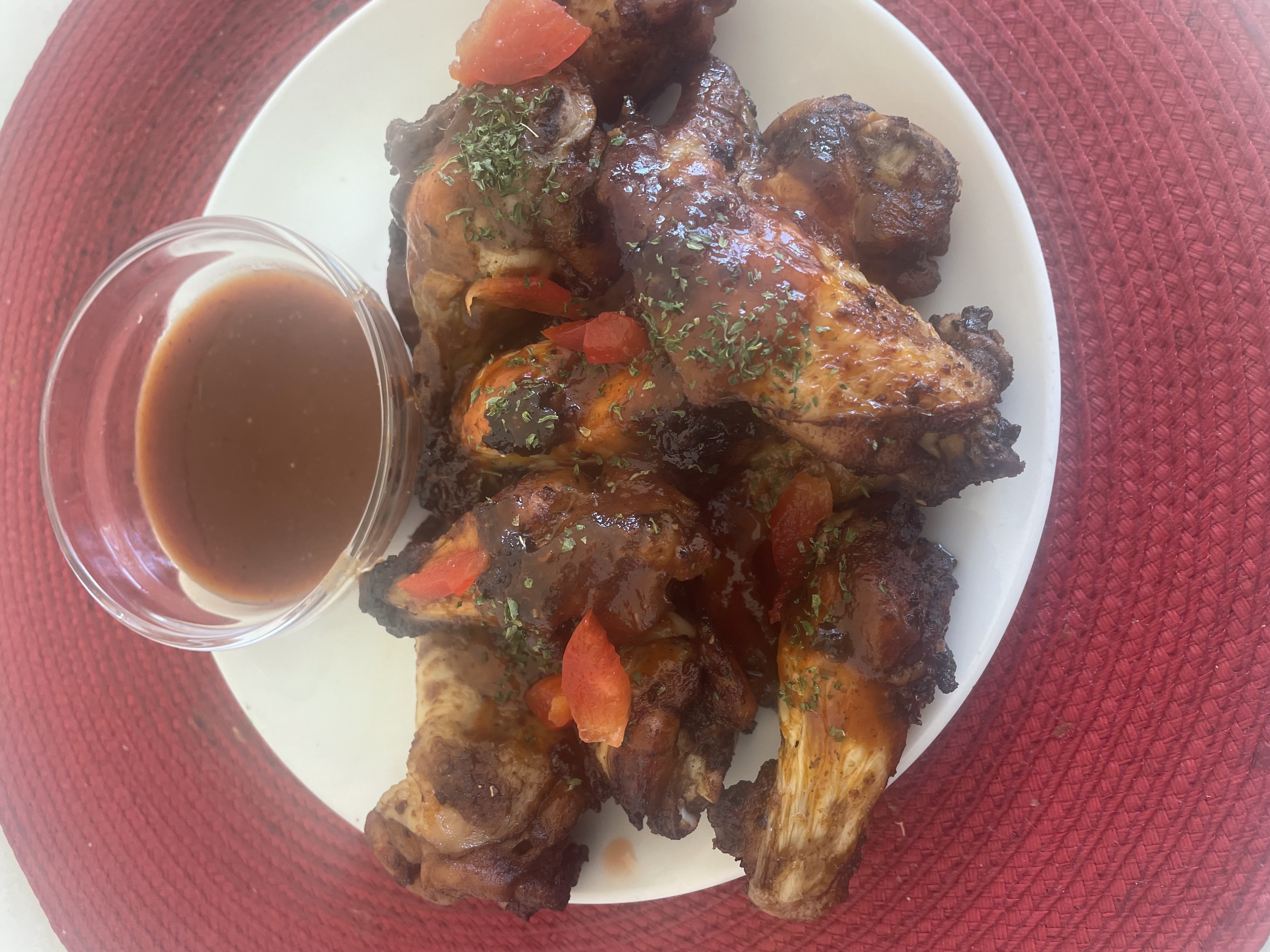 Plate of  Jamaica bbq jerk chicken wings with dipping sauce 
