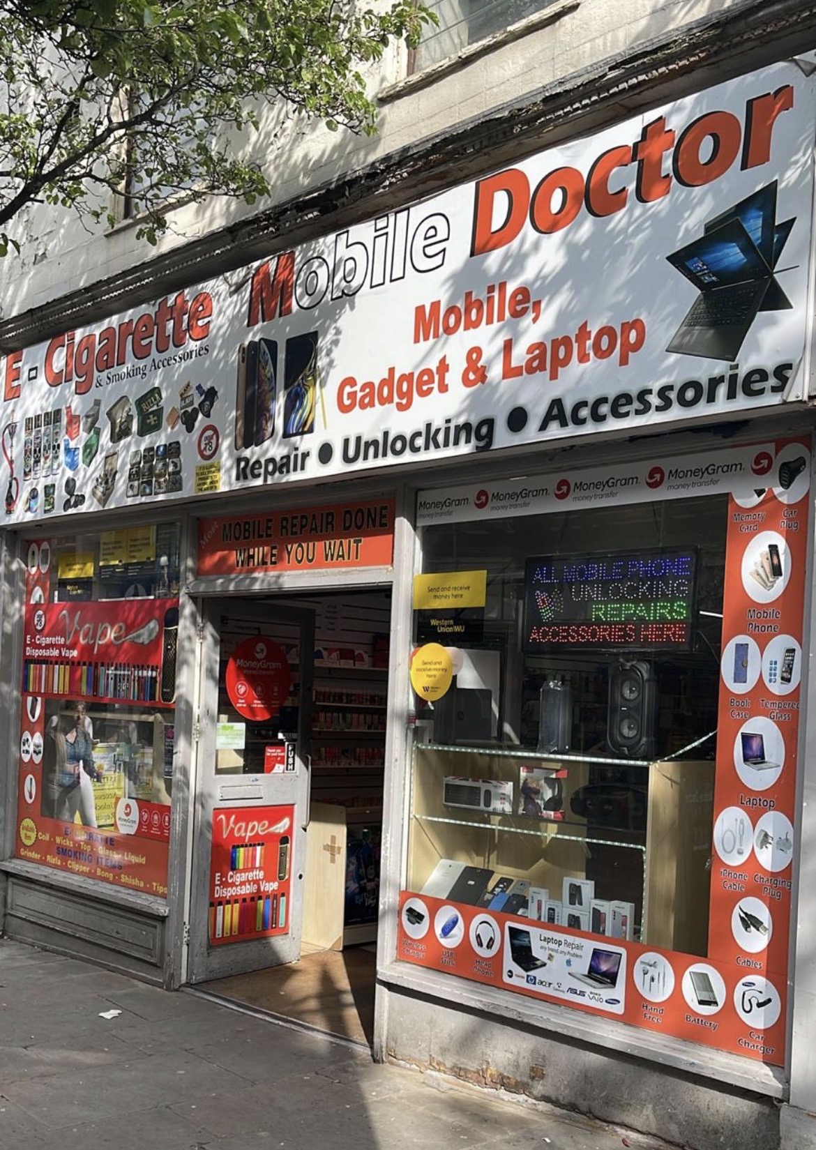 Colorful storefront with mobile repair and accessory signs