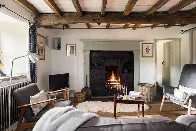 Nettlebed has a cosy sitting room with wood-beamed ceiling and inviting fireplace
