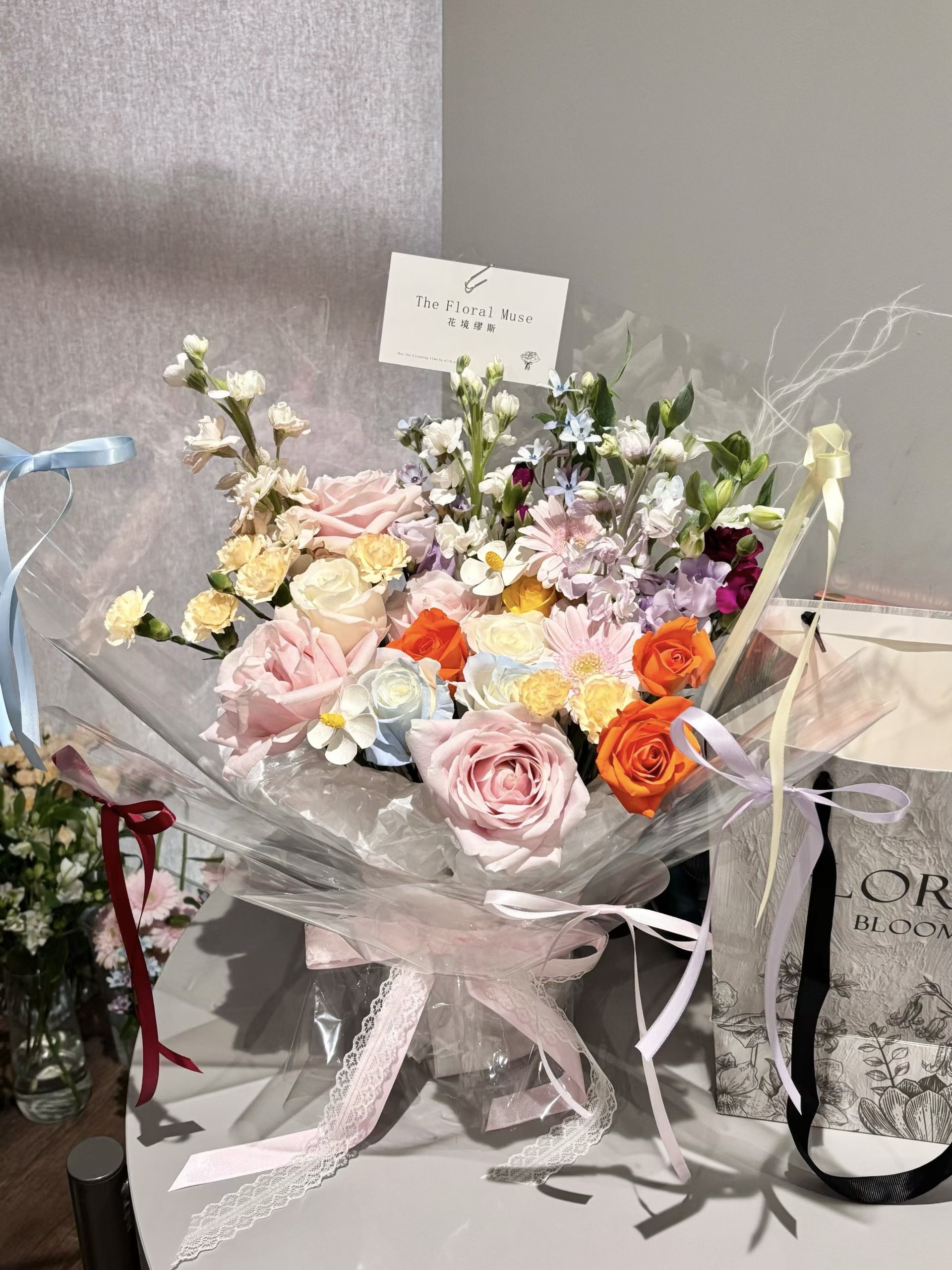 Colorful floral arrangement with roses and wildflowers in elegant wrapping