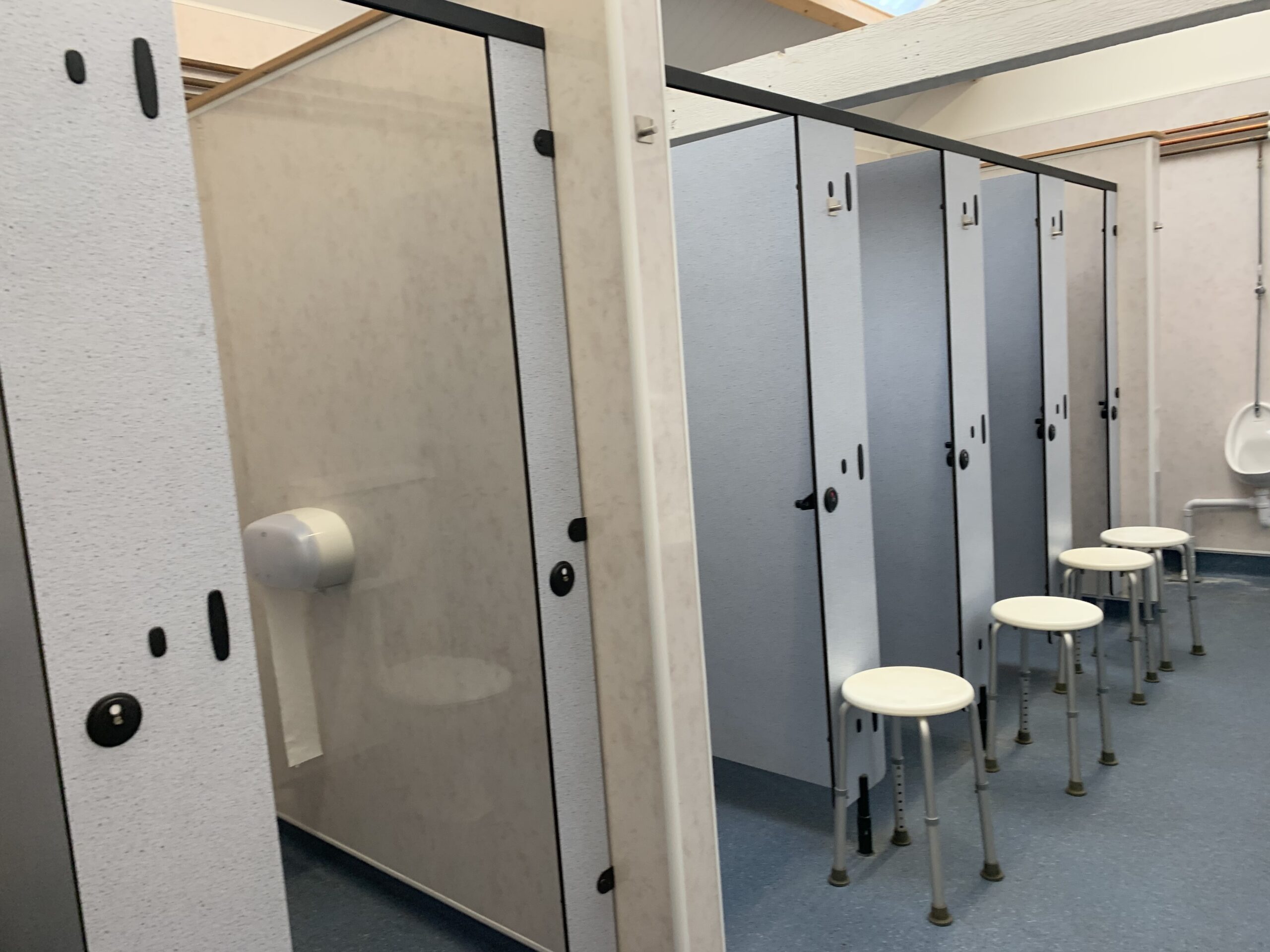Clean and spacious campsite bathroom facilities with individual stalls