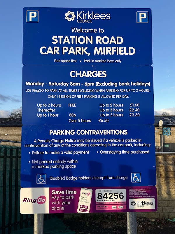 Sign for Station Road car park in Mirfield, detailing charges, rules, and RingGo parking information.